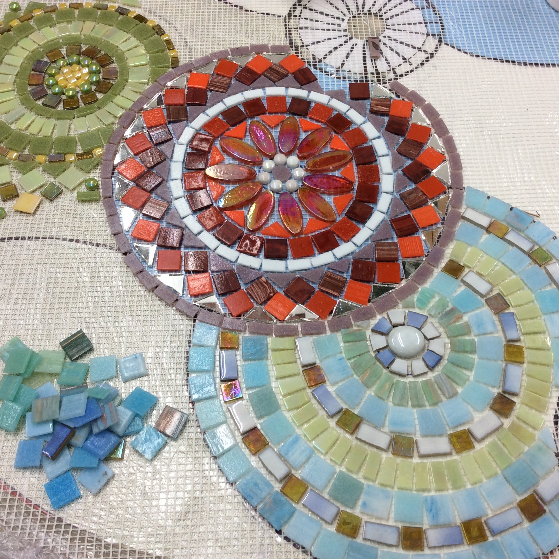 A simple design of overlapping circles made vibrant by the choice of glass and ceramic tiles and how the colours and textures are placed together to create both clarity and flow.