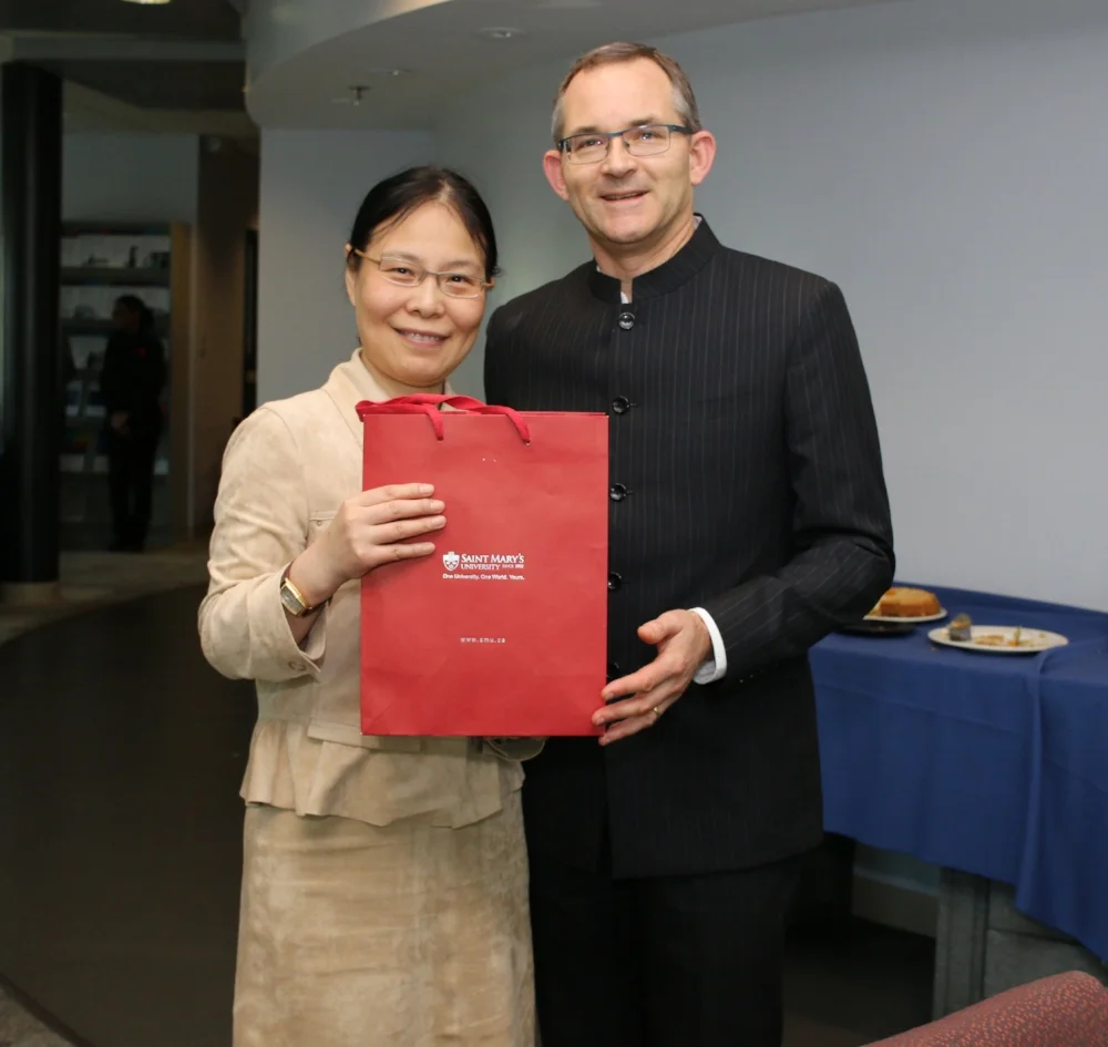 Maria Pan receives a gift of appreciation from President Rob Summerby-Murray