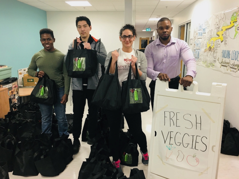 Service learning students working with the Square Roots Bundle Program: (l-r) Joseph Henry, Hongwoo Kim, Stephanie Ibrahim, Gavin Grant