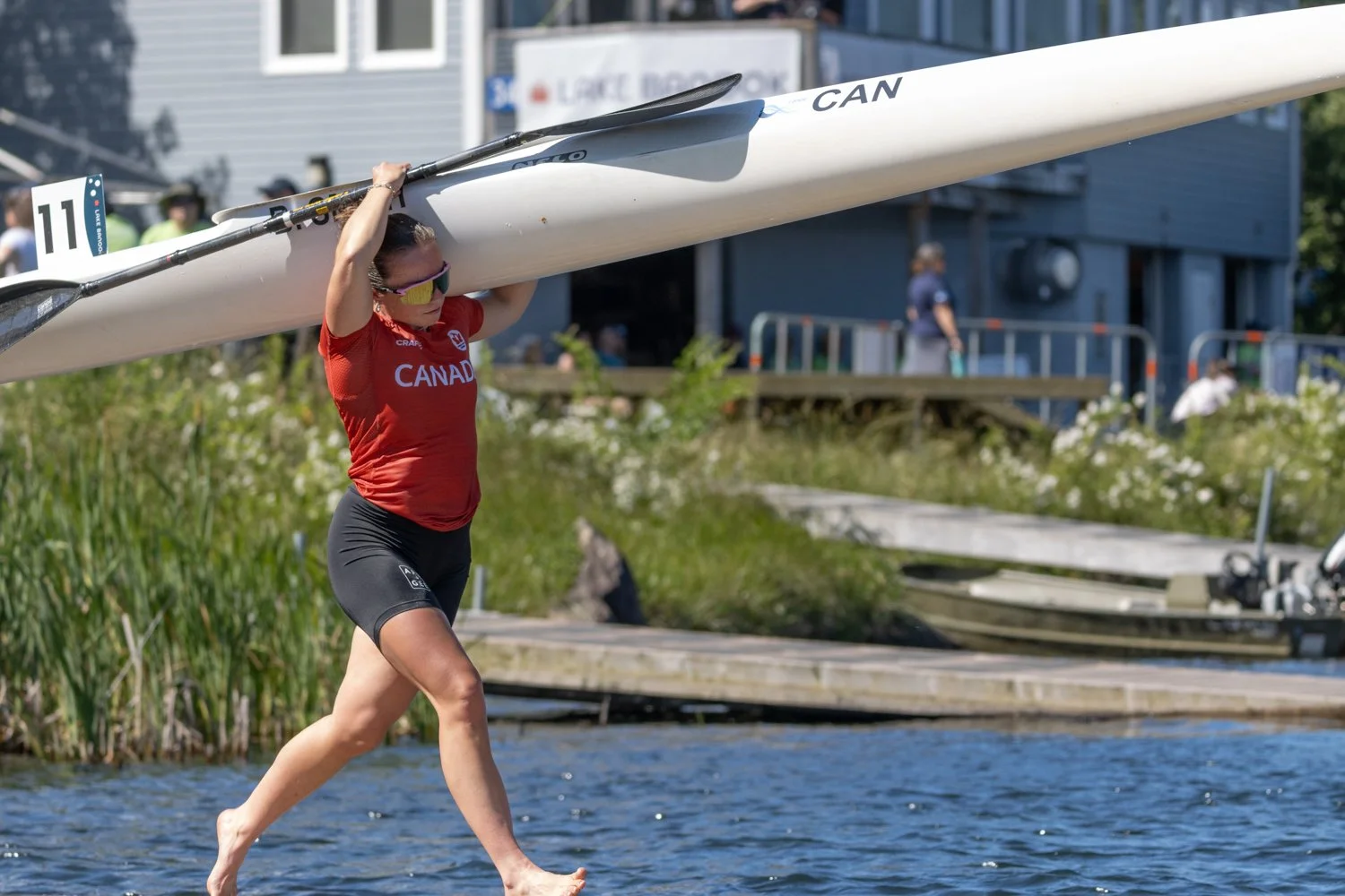 Brianna carries a kayak into the water