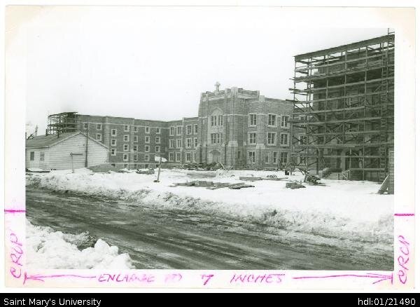  Photograph of construction of McNally Building in winter, scaffolding in place, taken from Robie Street facing northeast. There are no shacks in photos taken early in the construction, so likely the one in this photo serves as a winter HQ and heated