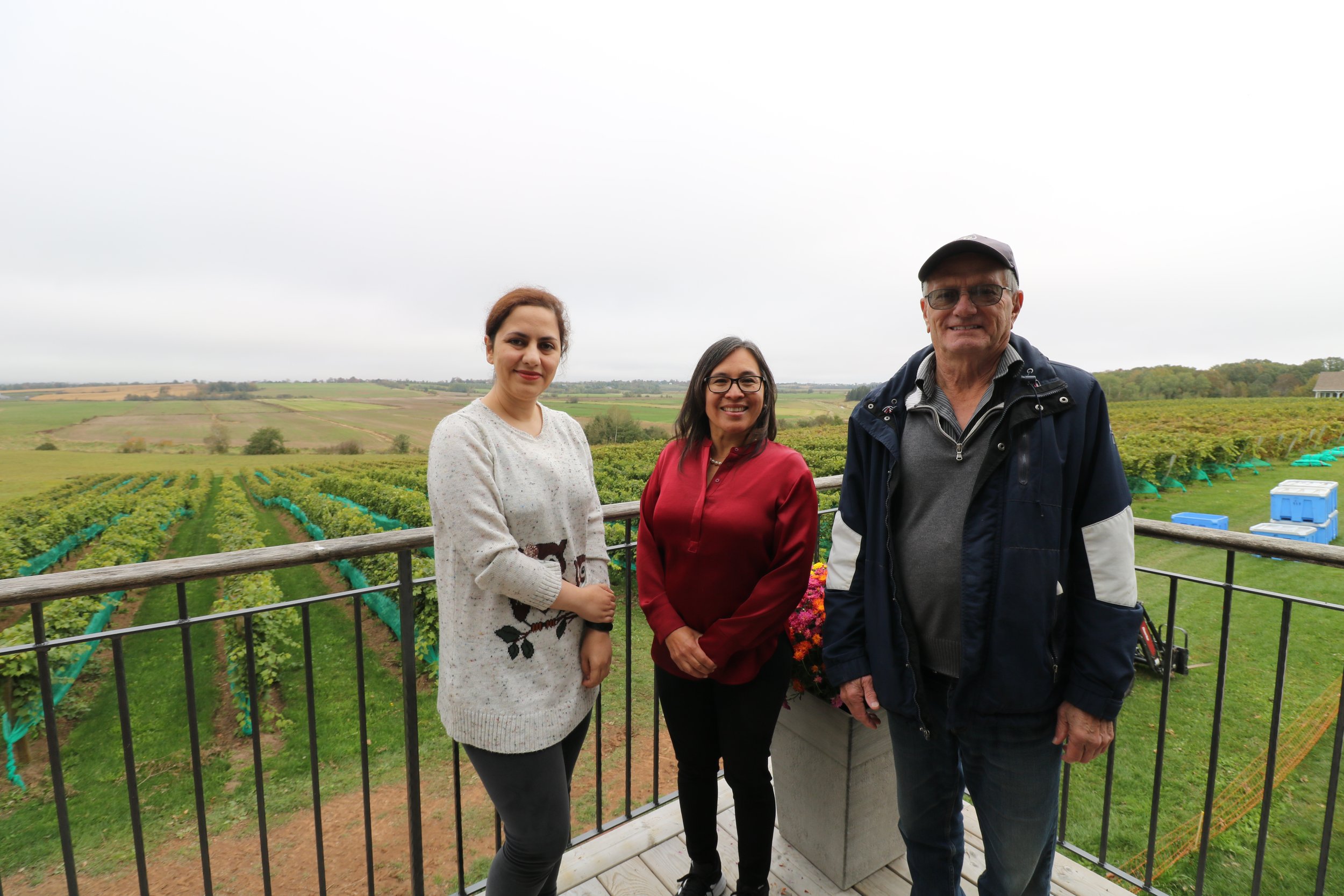  De Fuentes, Seyedjafarrangraz and Mclarty stand with Planters Ridge vineyard behind them 