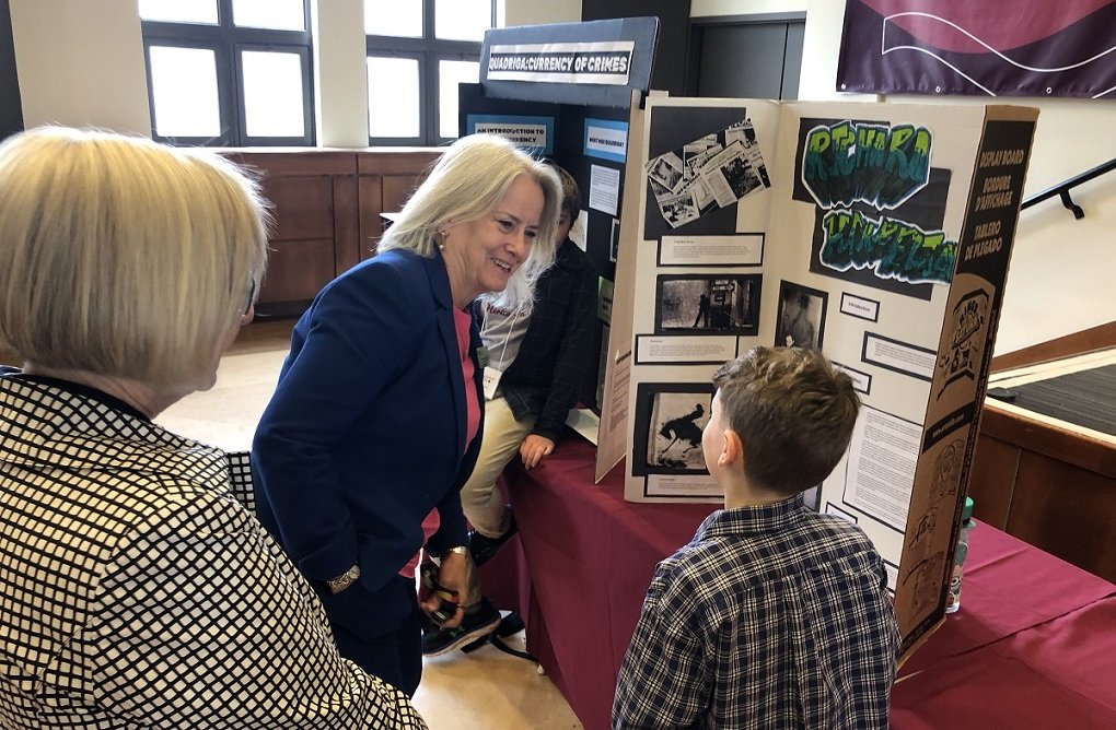  Dean of Arts, Dr. Mary Ingraham, learns from a Heritage Fair presenter  