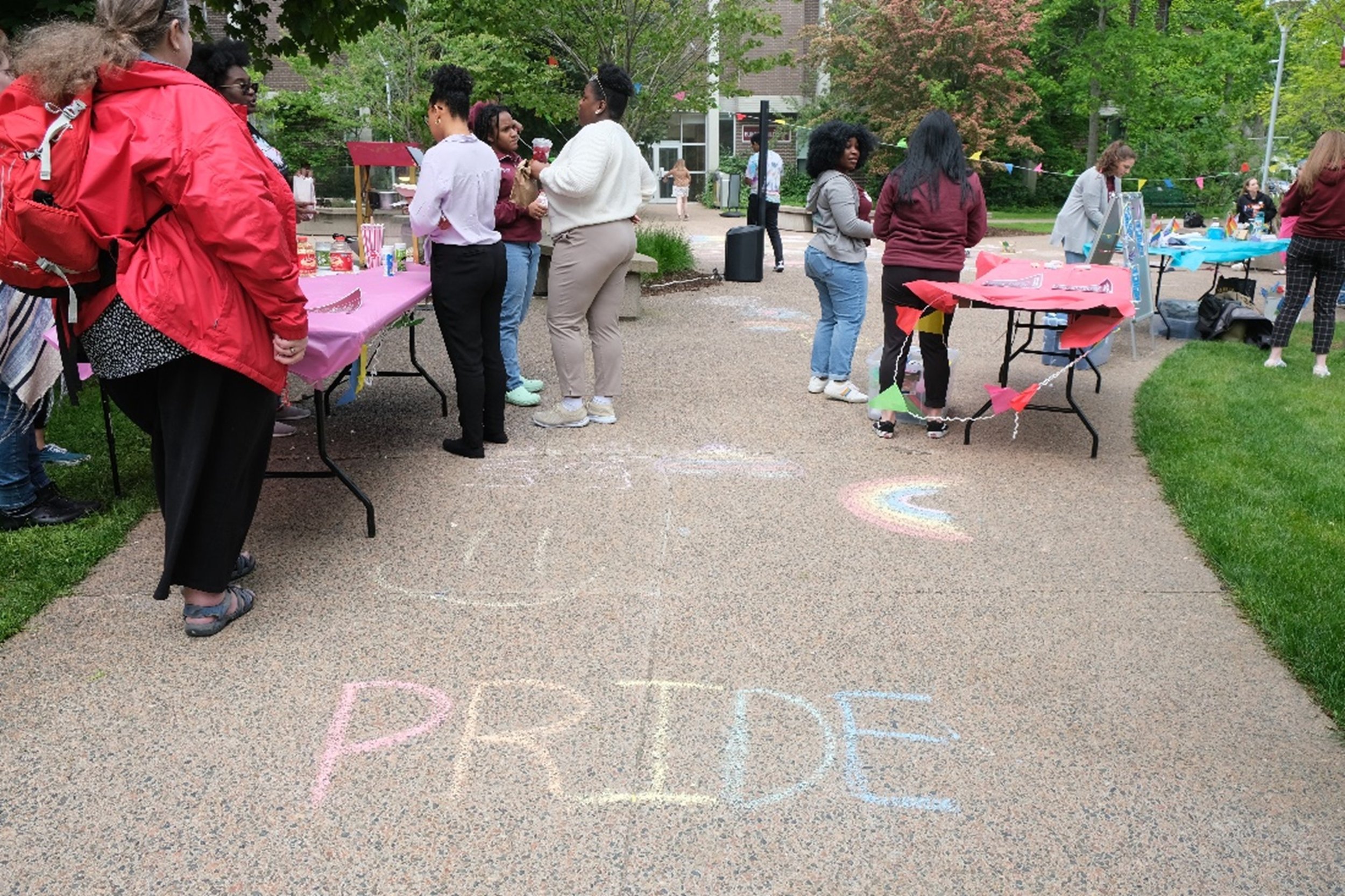  Group of people visiting Pride activity tables in Saint Marys Quad. 