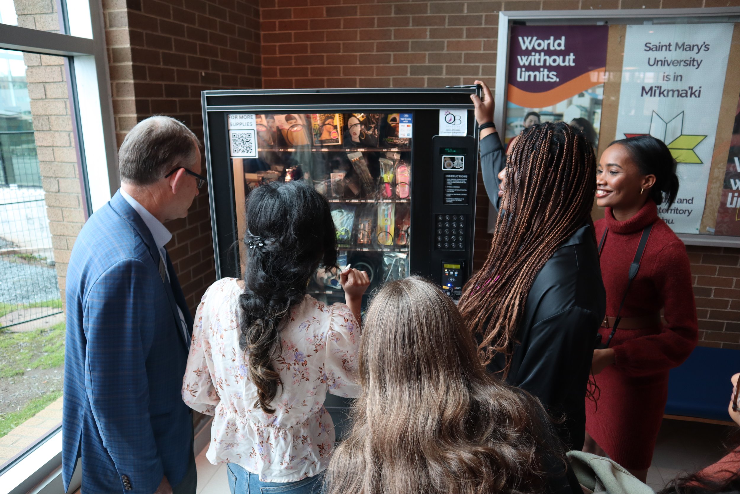  Event attendees looking at the new vending machine 