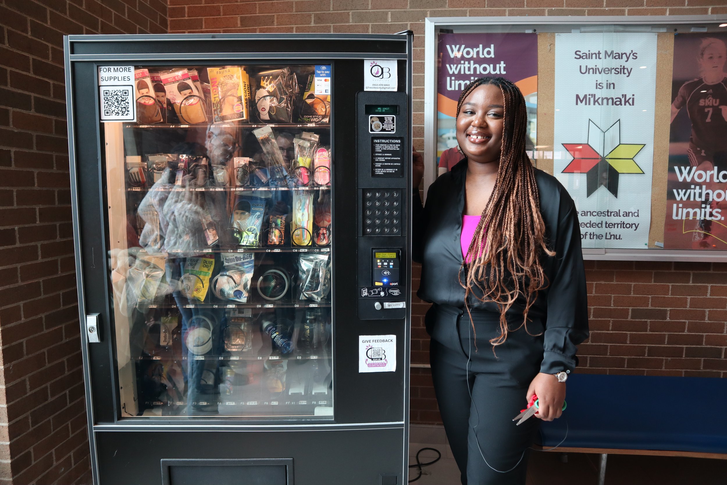  Queen-Esther with the QTress Beauty Supplies vending machine on campus 