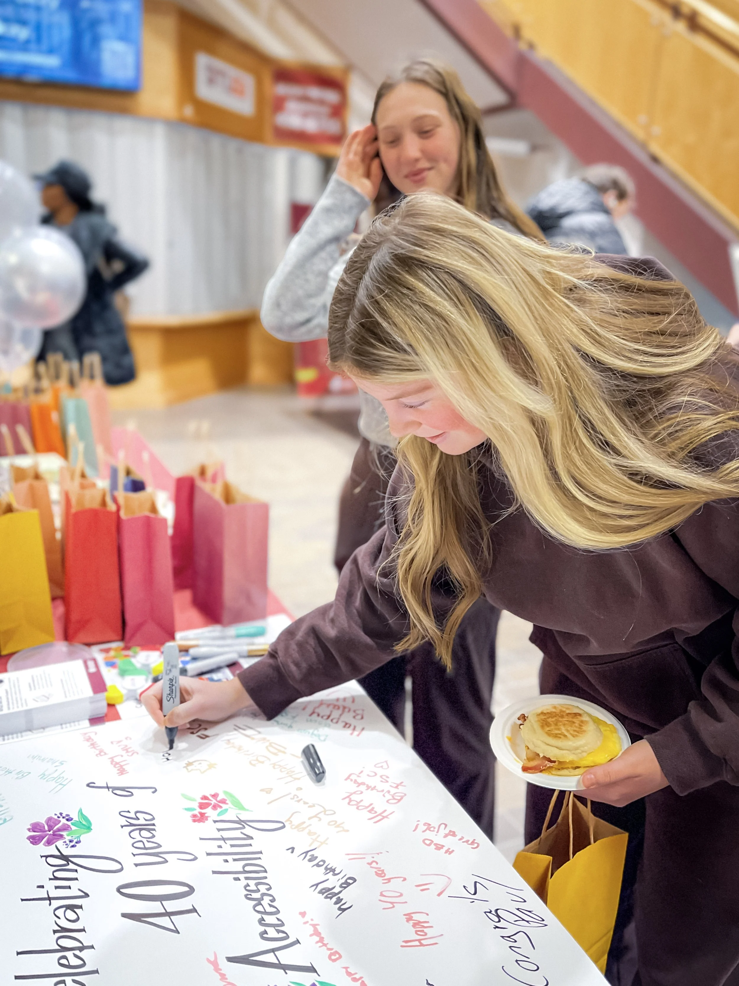  A student writes on a birthday card for the FSC 
