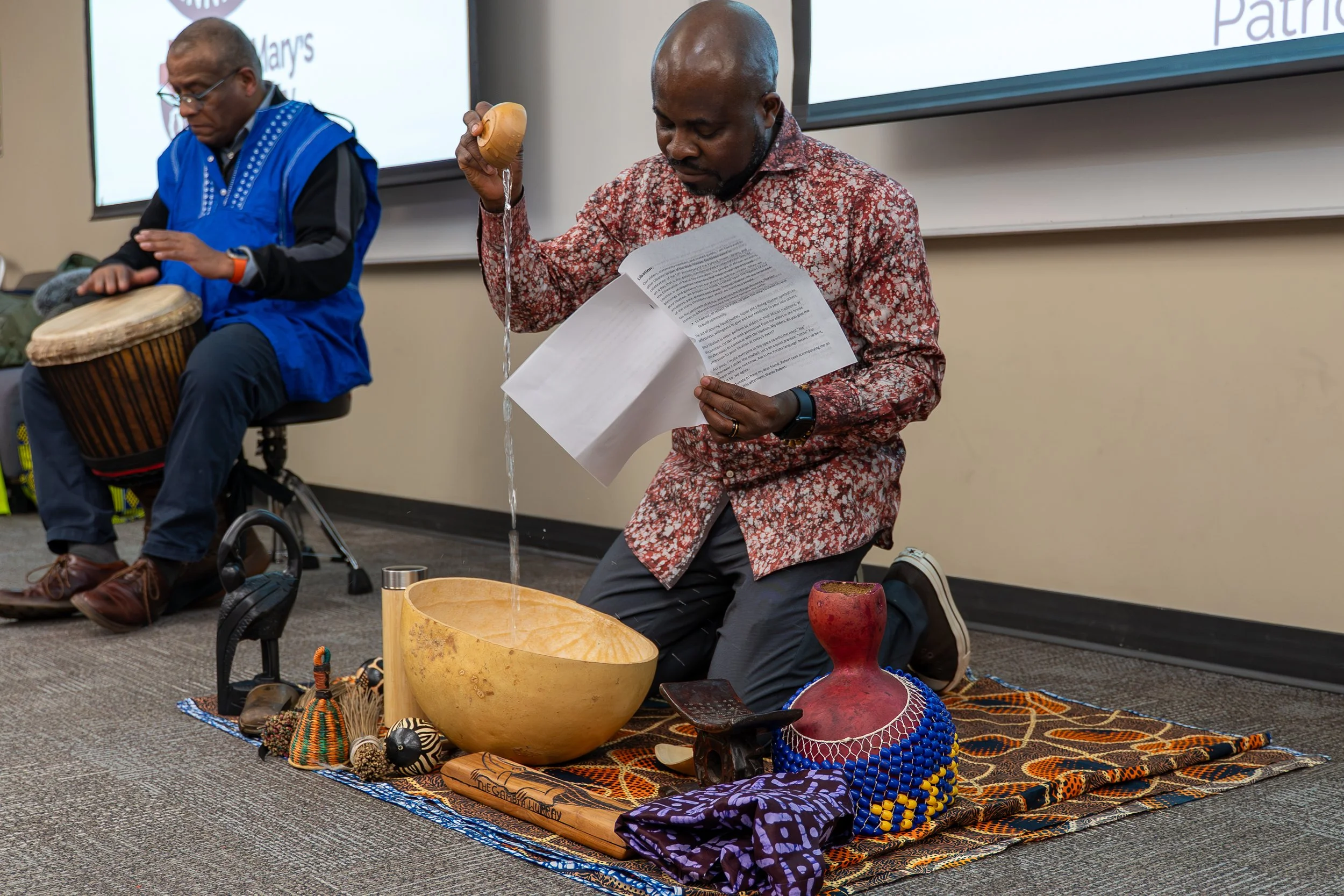  Ayo Aladejebi and Robert Meek conduct a libation ceremony 