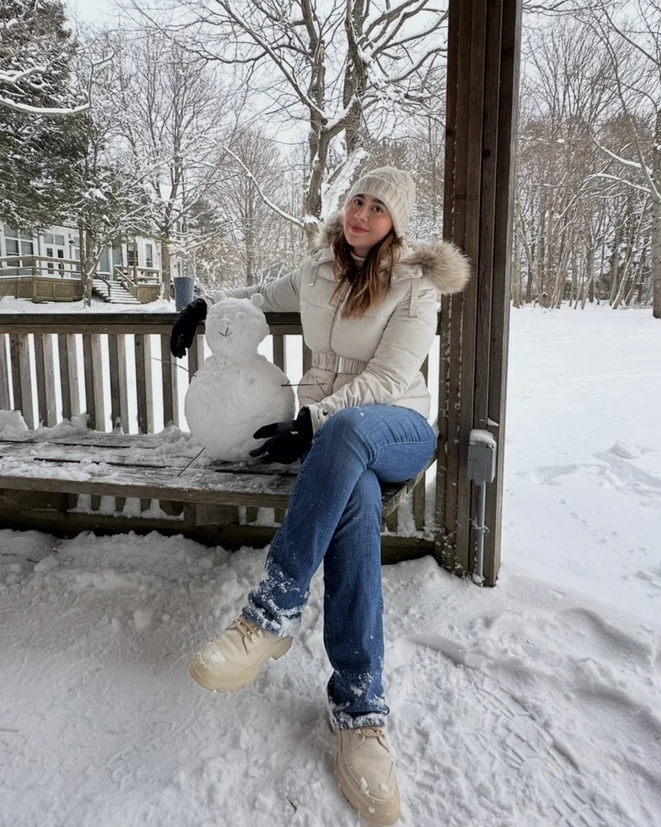 Melissa with a small snowman on campus