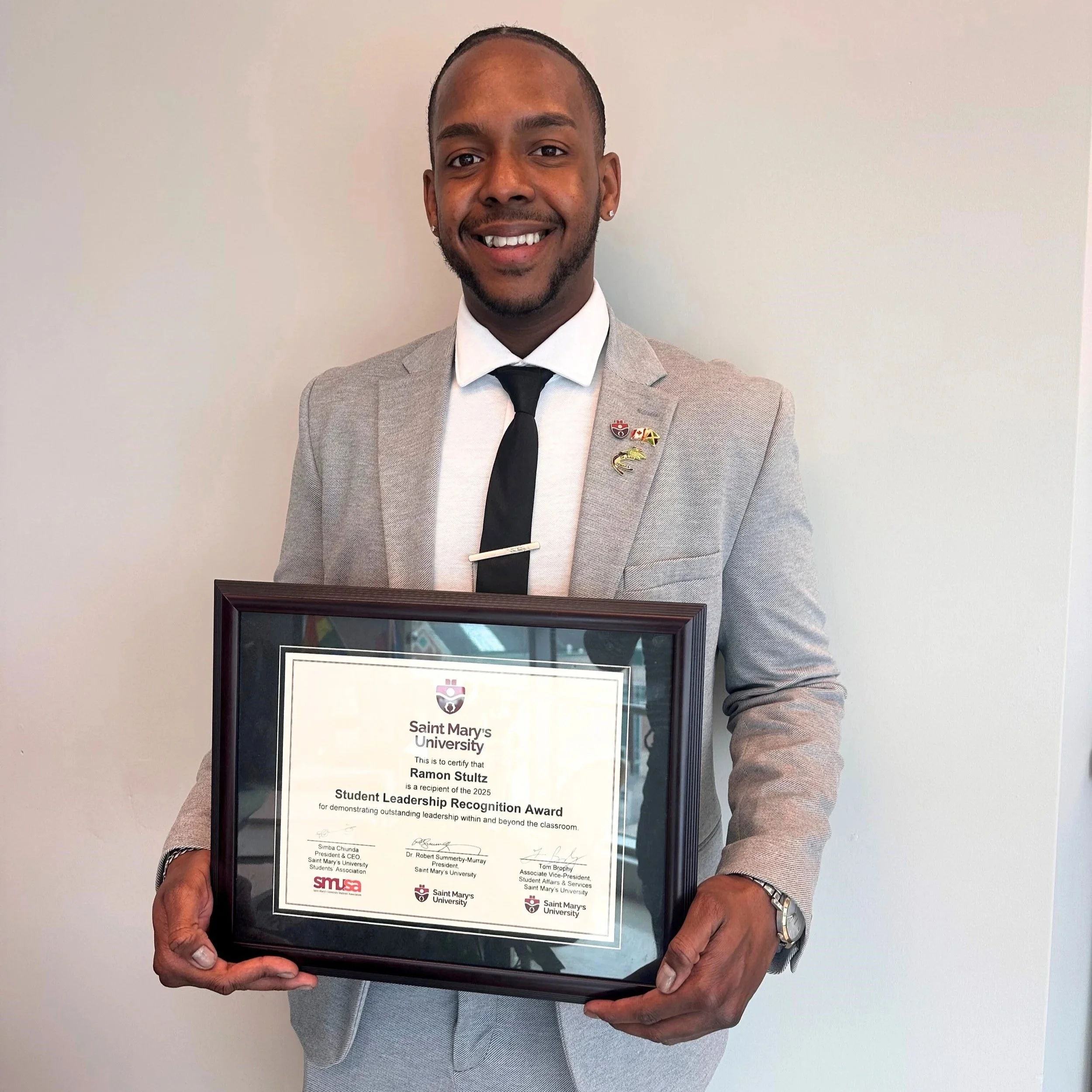 Ramon holds his leadership award certificate