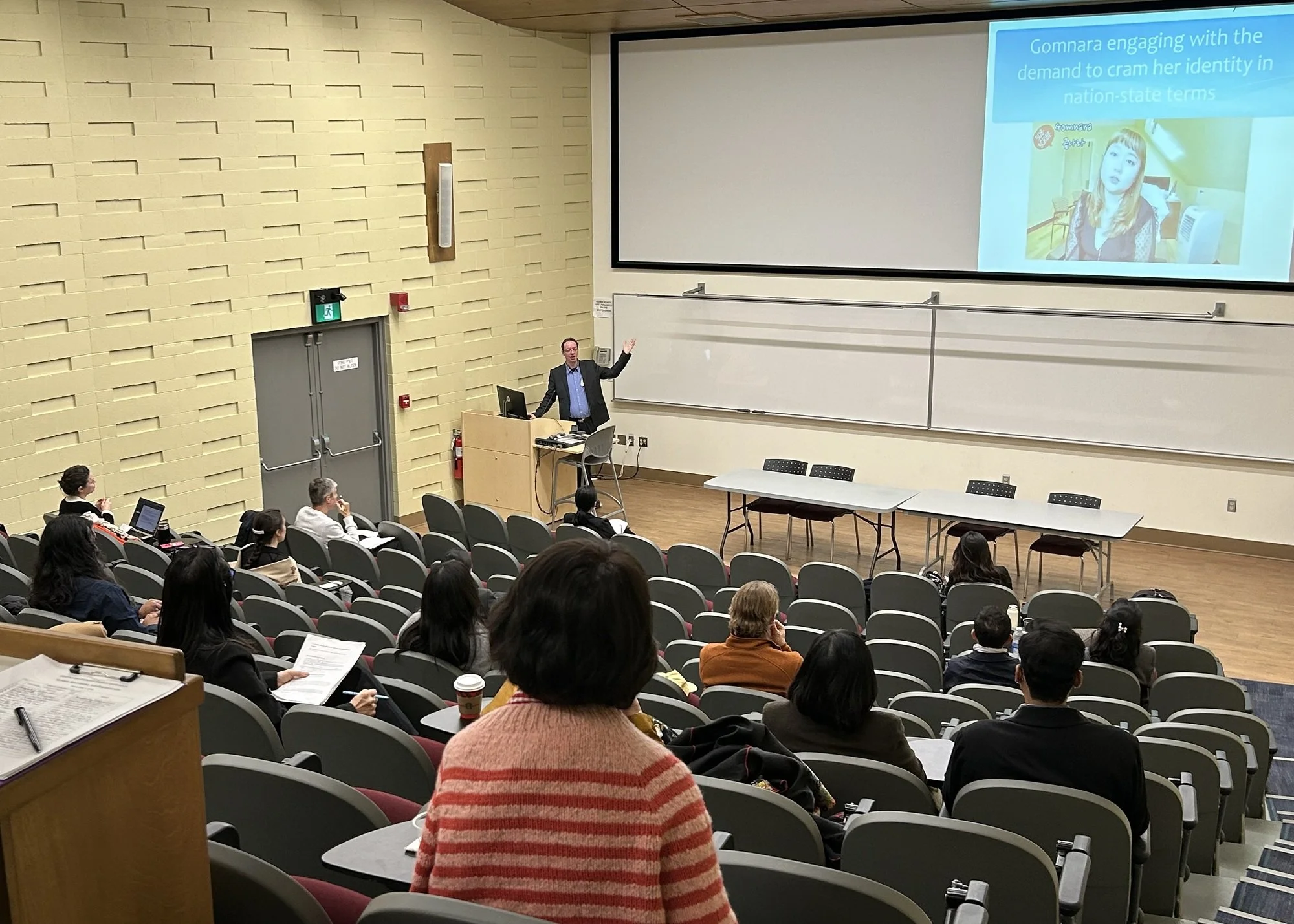 A man presents in a lecture hall
