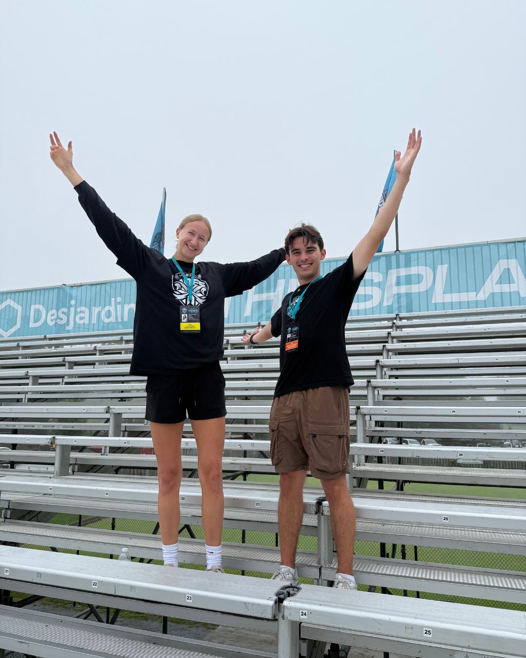 Katelyn and Ben pose on the bleachers at the Tides soccer stadium