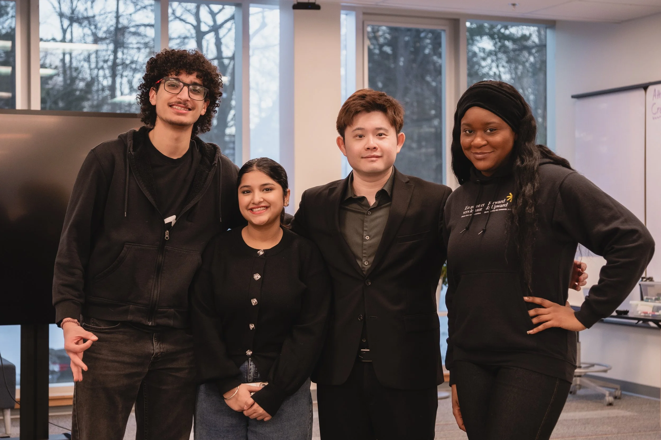 Three students pose with Richard Yang