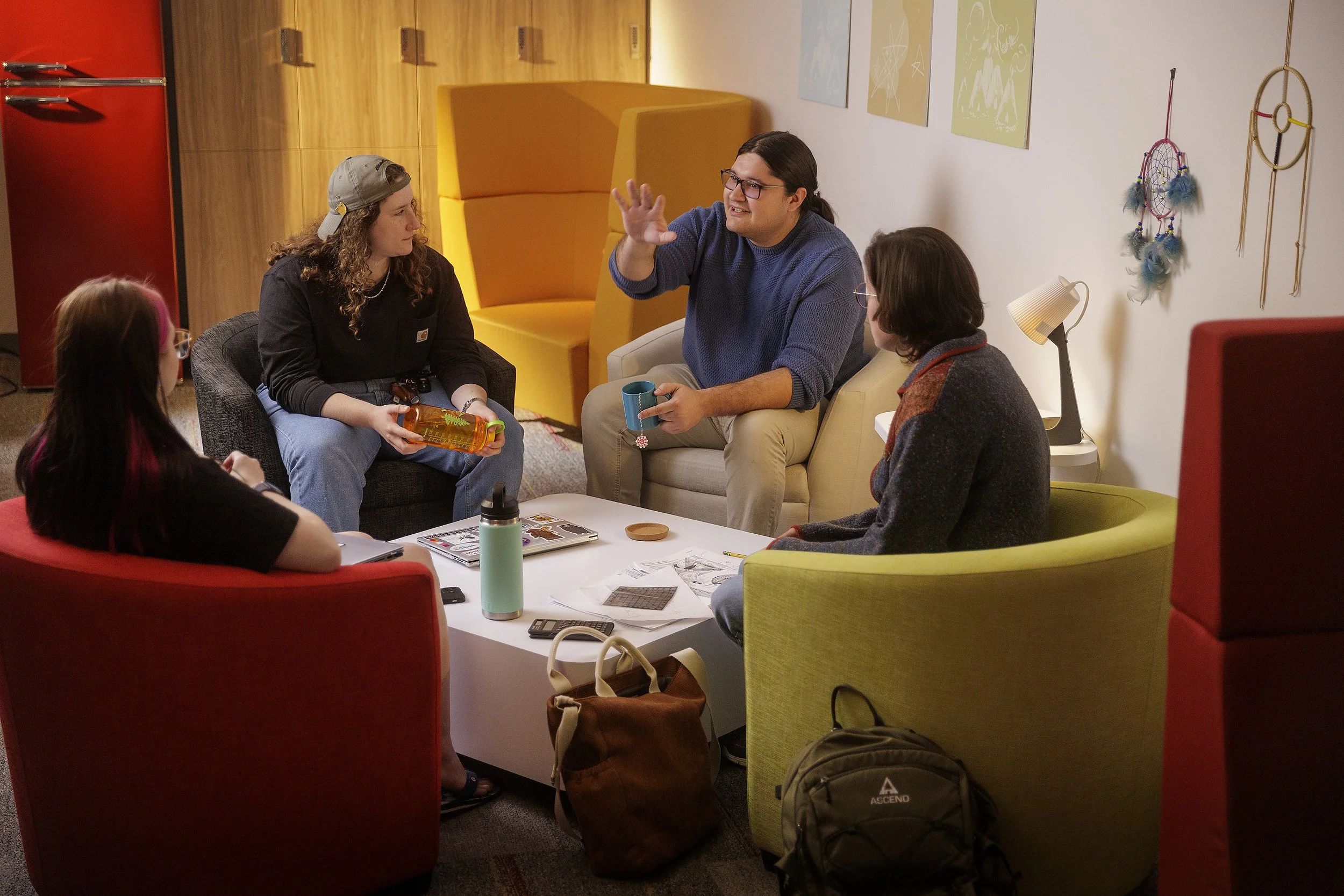 Kylar and students gather in the Qomuti space