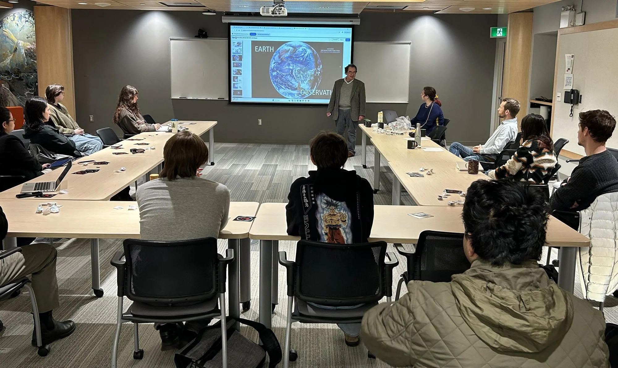 A man presents in a classroom with students
