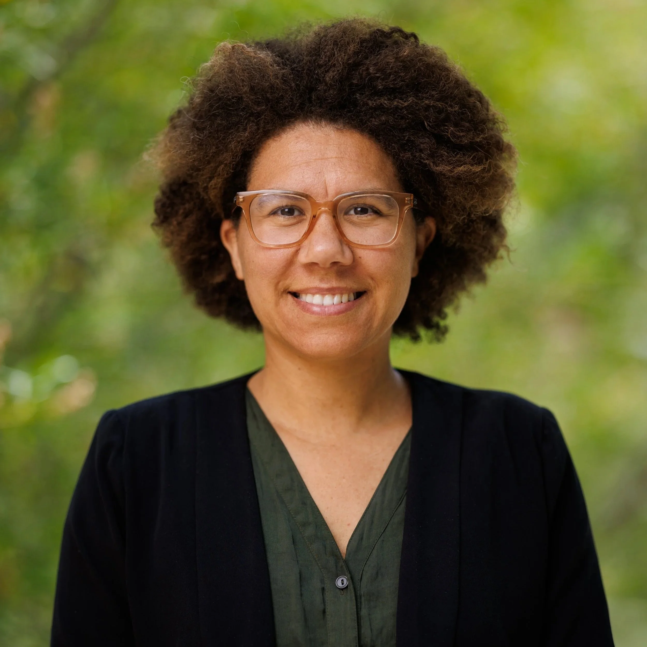 Louise with some trees behind her