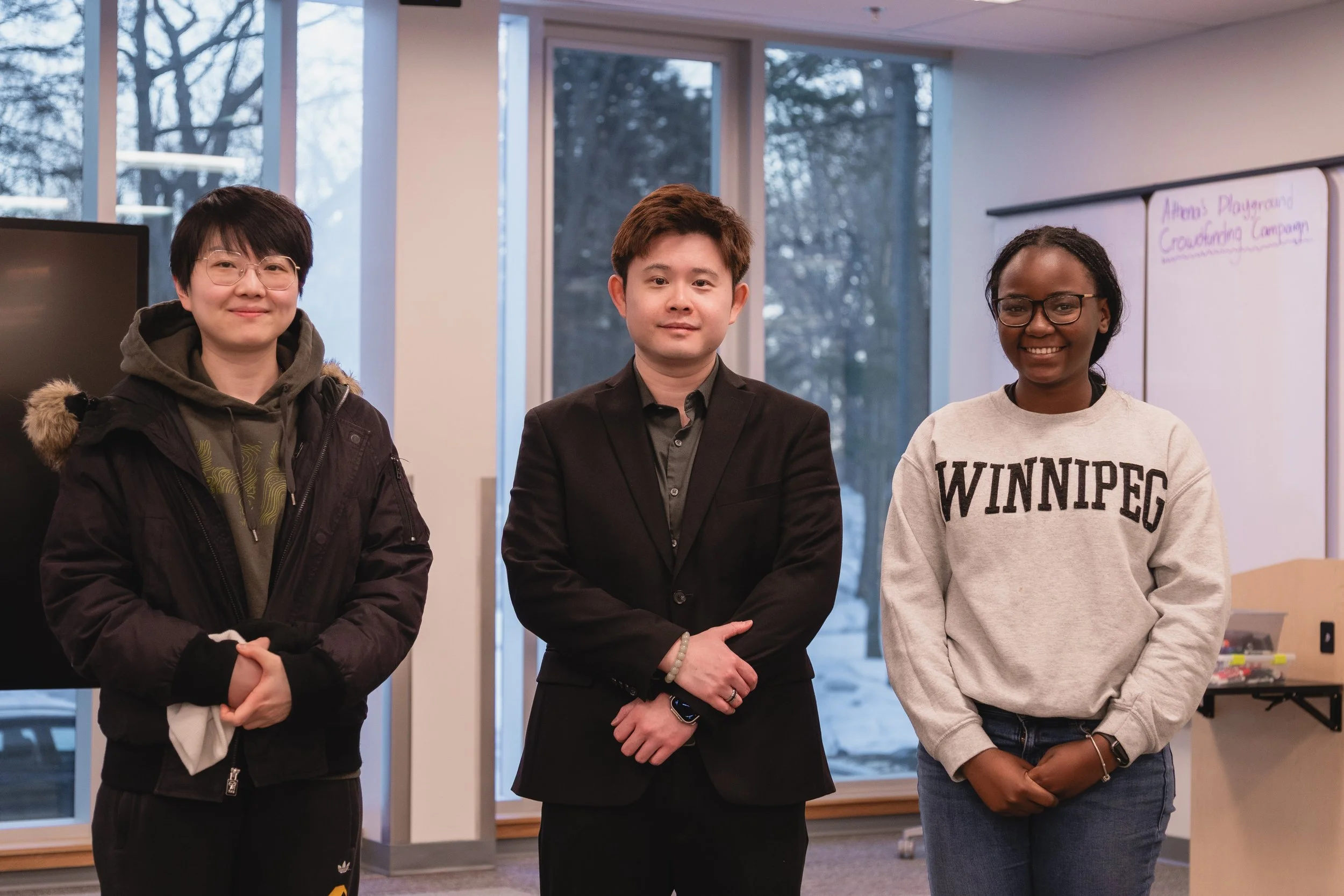Two students pose with Richard Yang