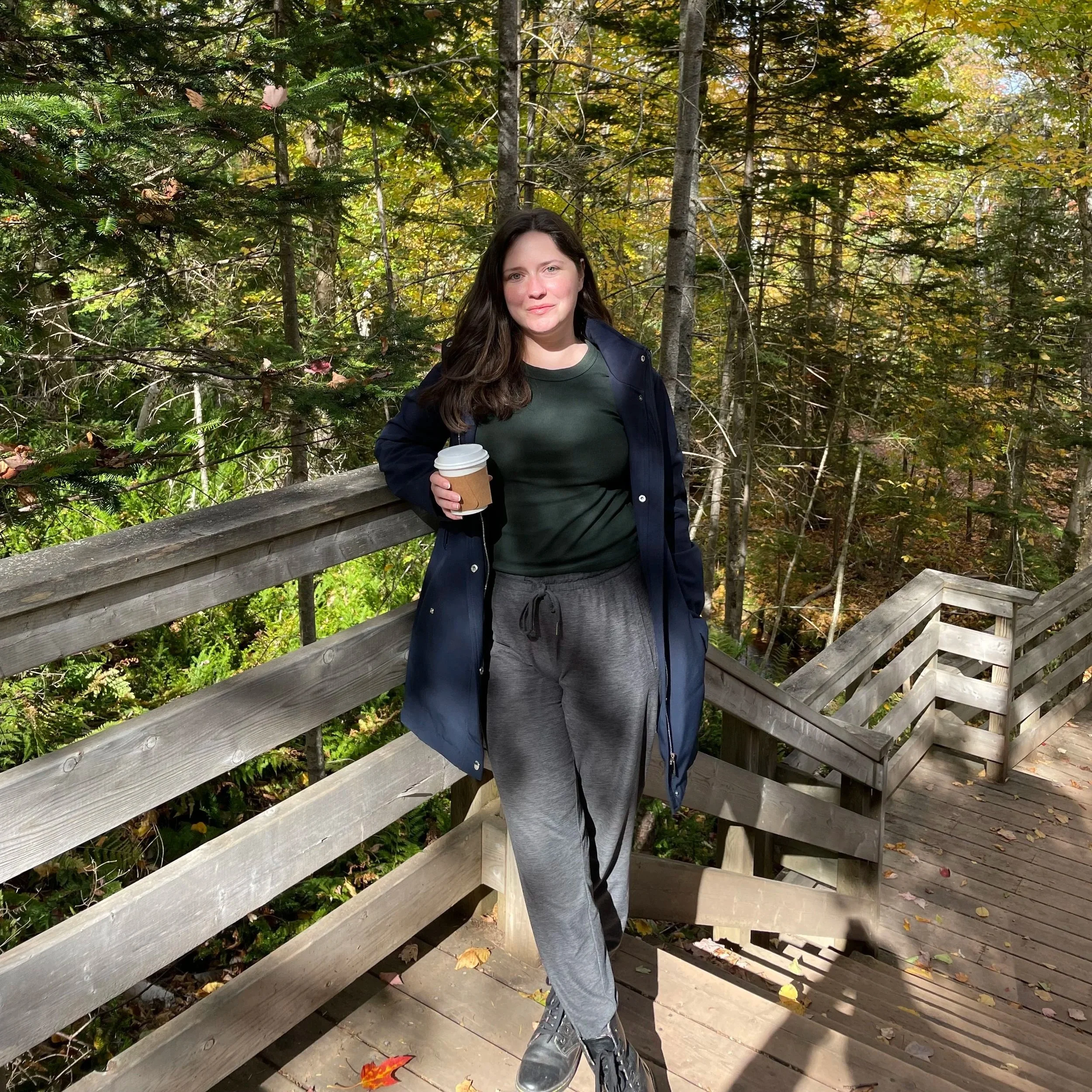 Brittany stands outdoors on a walking trail