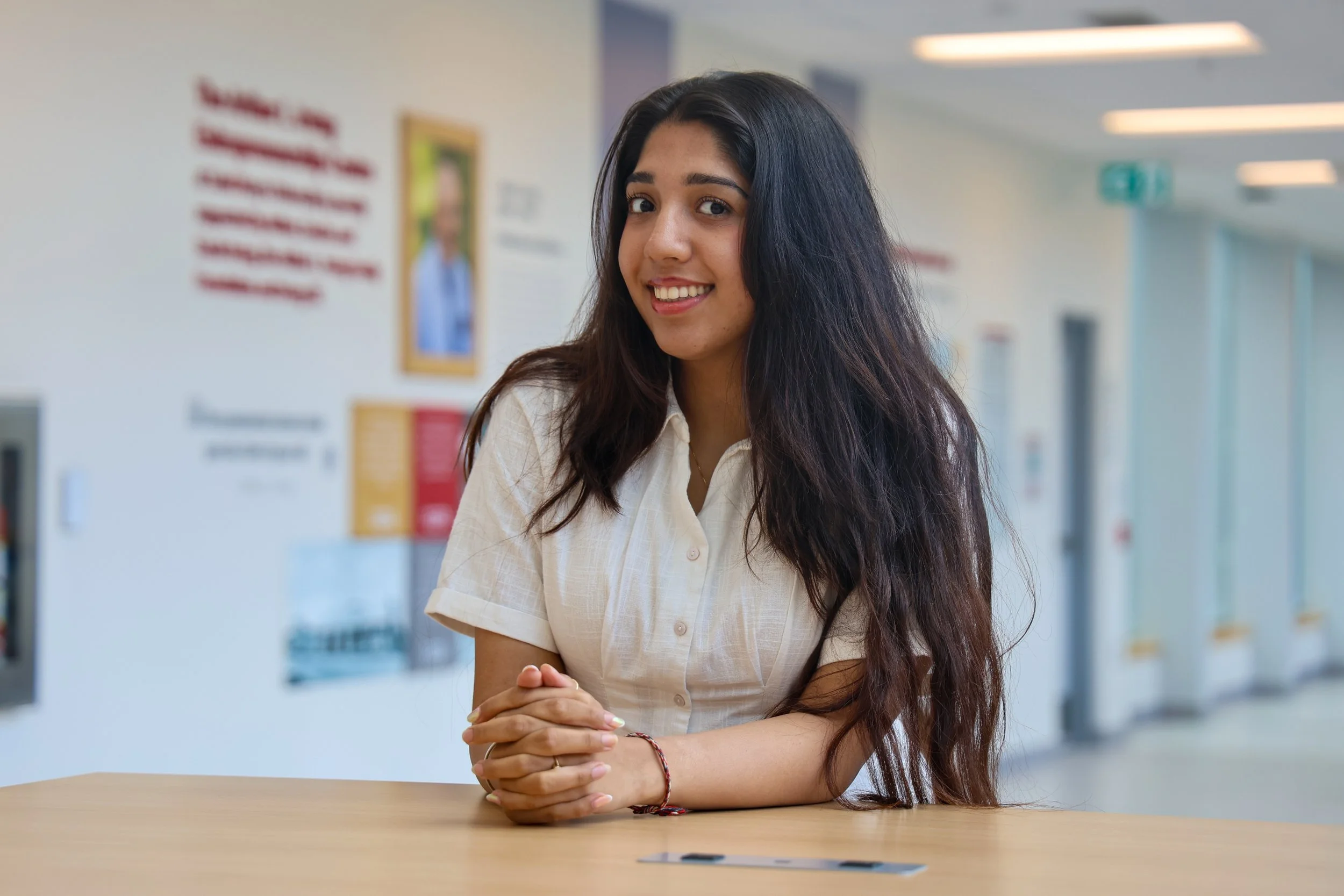 Stuti is a young woman with brown skin and long brown hair. She smiles in front of the Entrepreneurship Centre.