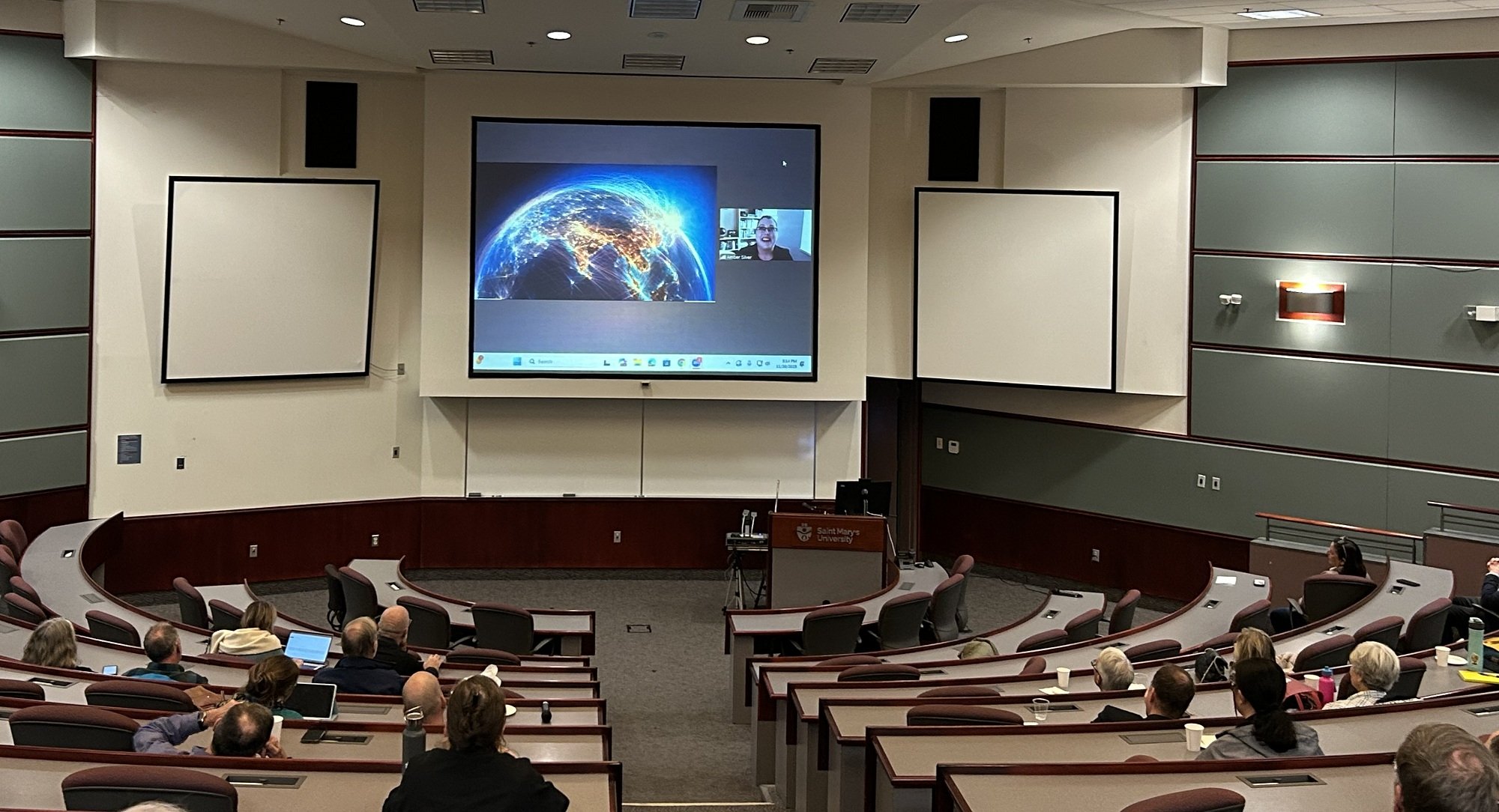 Amber shown on a projector screen in a lecture hall
