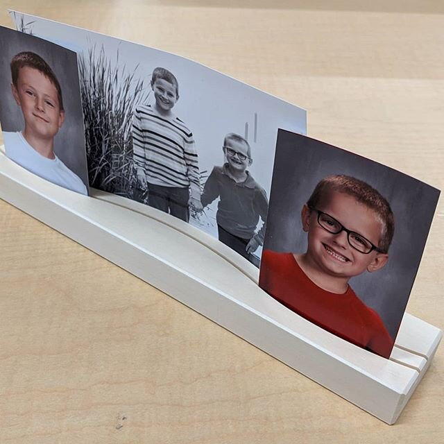 Having access to a CNC machine at work has its perks. I whipped up this photo display for my desk. Routed out a couple wavy lines with a 1/16&quot; bit, 1/4&quot; deep, and the kids' photos stand up nicely.

#wood #woodworking #xcarve #cnc #deskdecor