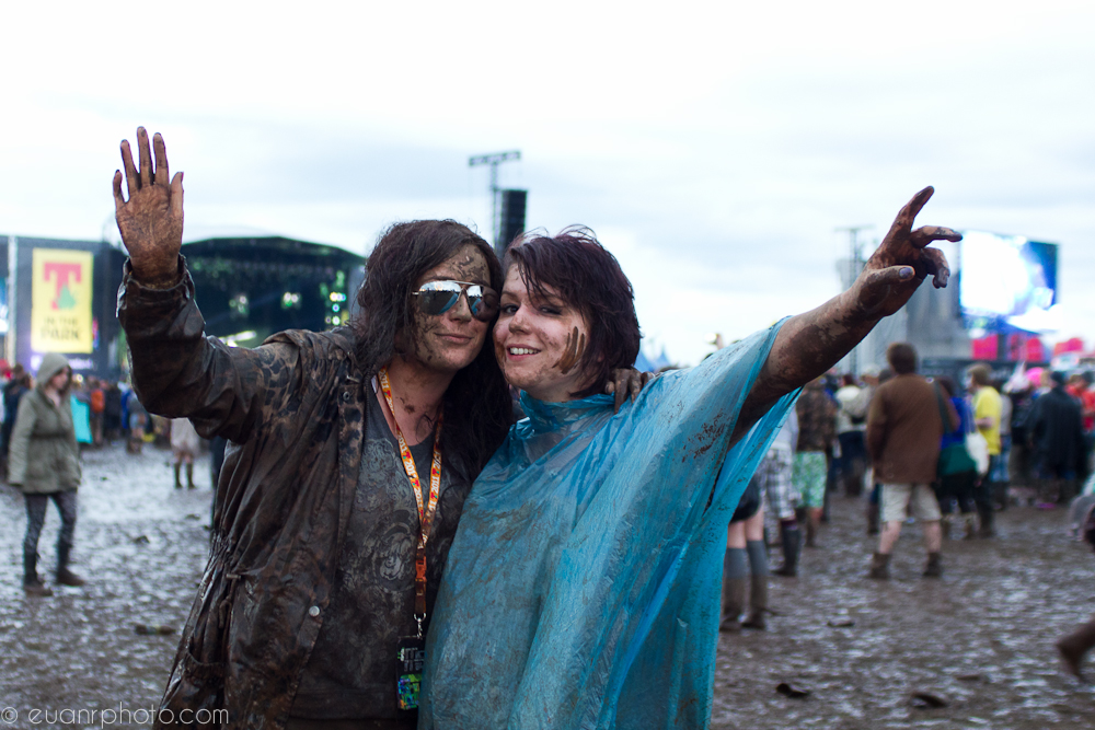  Girls make the most of the mud as they enjoy Foo Fighters play on the main stage 