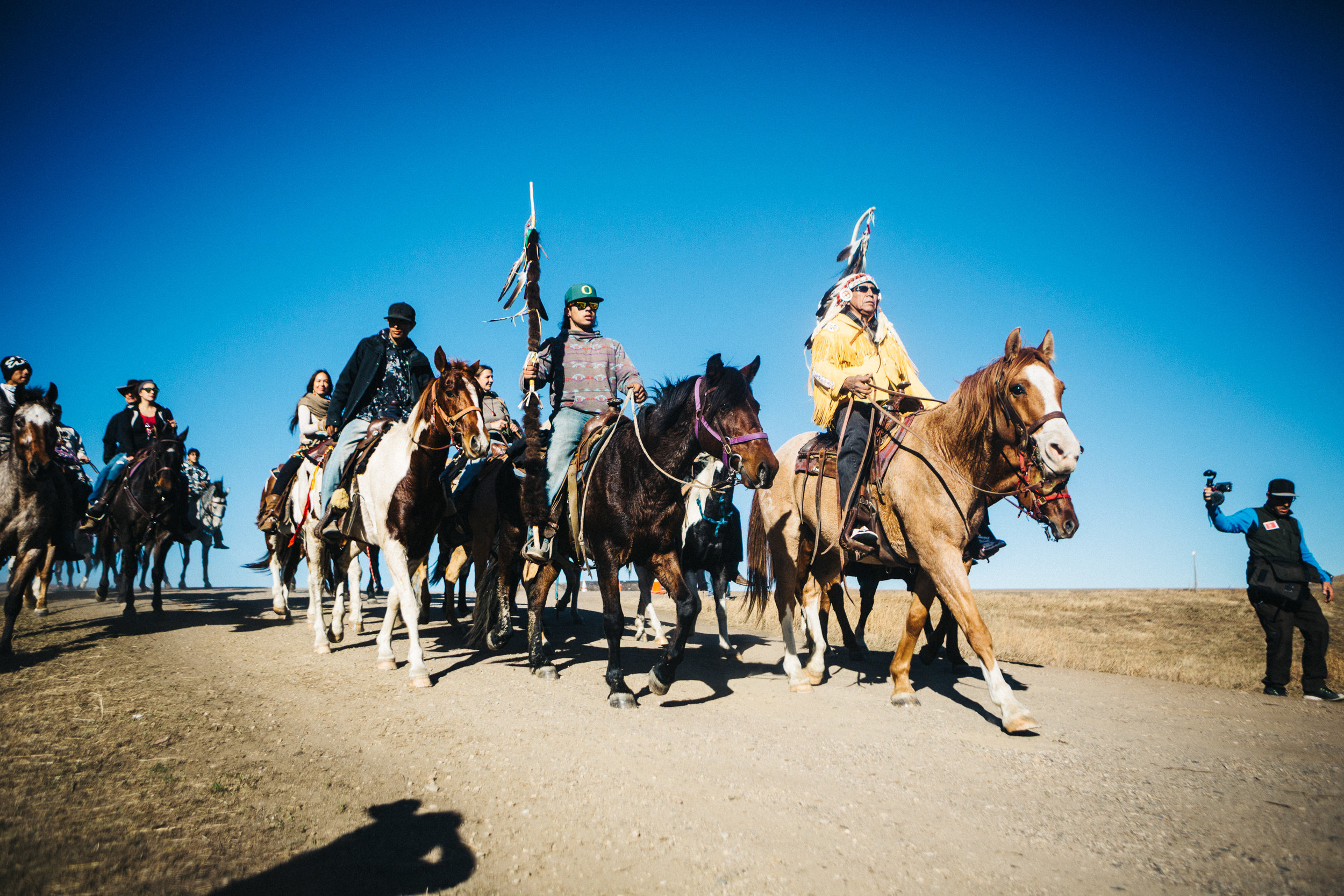 Arvol Looking Horse leads a group of Lakota riders into the Oceti Sakowa Camp for a sacred ceremony.