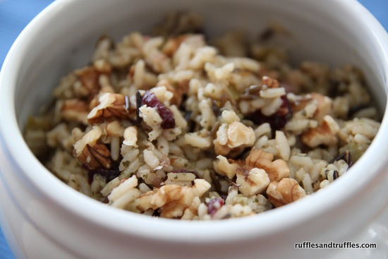 Henderson--Inspired Walnutted Wild Rice 1 cup golden raisins 1/2 cup dry sherry 1 cup wild rice 1 cup of brown rice 4 2/3 cups of chicken broth 3/4 stick or less of unsalted butter 1 cup of walnut halves salt, pepper and parsley to taste Simmer raisins in sherry for about 5 minutes and set aside. Cook the wild rice with two tablespoons of butter and 2 cups of chicken broth over the top of a double boiler for about one hour. Cook brown rice in remaining chicken stock with 2 tablespoons of butter by heating to boiling point and then reducing heat to low until all liquid absorbed in about 50 minutes. Saute the walnuts in remaining butter. Combine all and season to taste. Enough for 8-10.