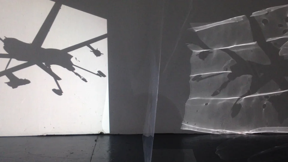 The last 2 screens are constructed from translucent acetate film. The acetate film refracts and bends the video projections that pass through it to reach the vellum screens and architecture of the space.