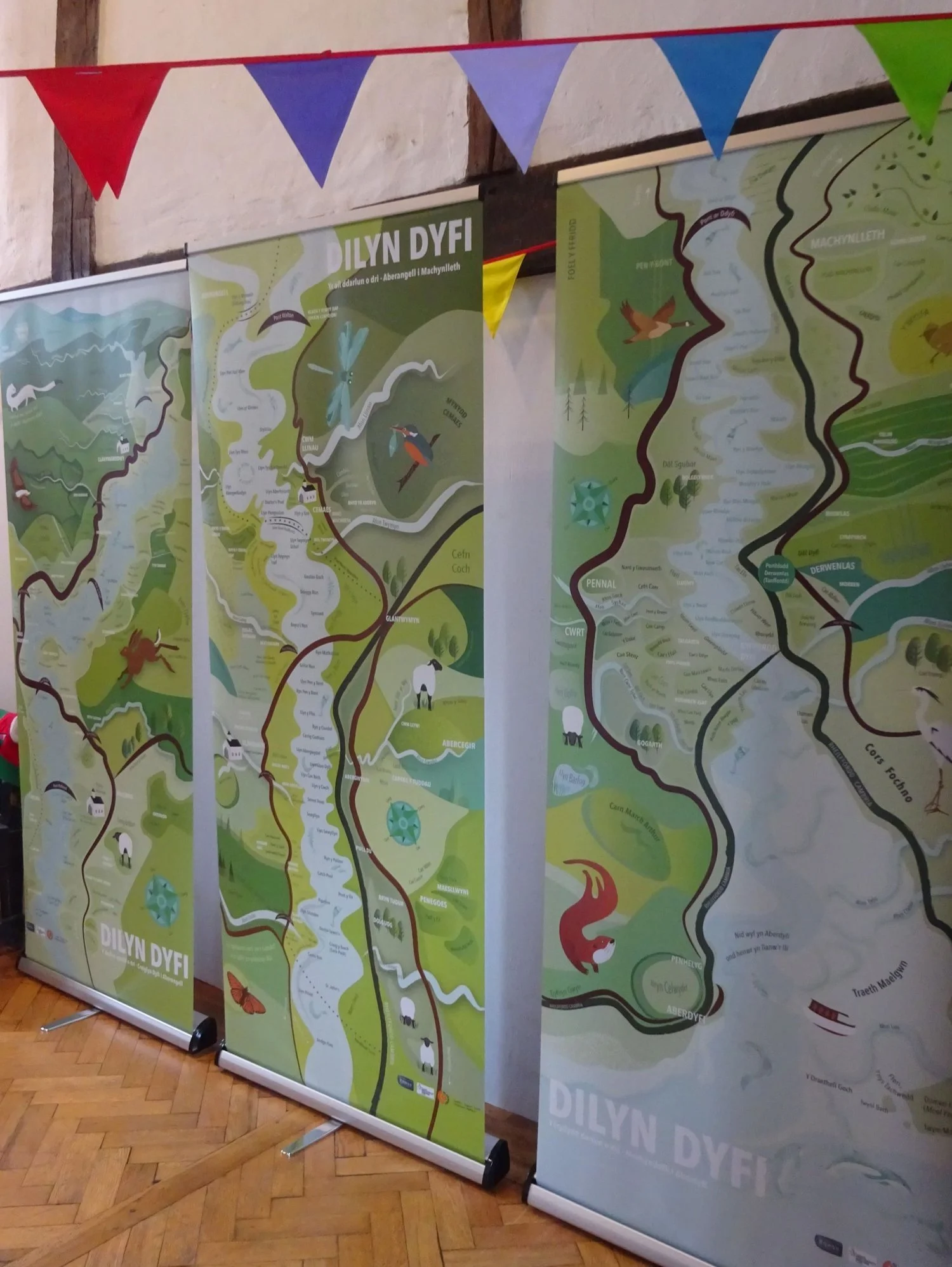 Illustrated banner display graphics of local Welsh place names in the Dyfi valley.