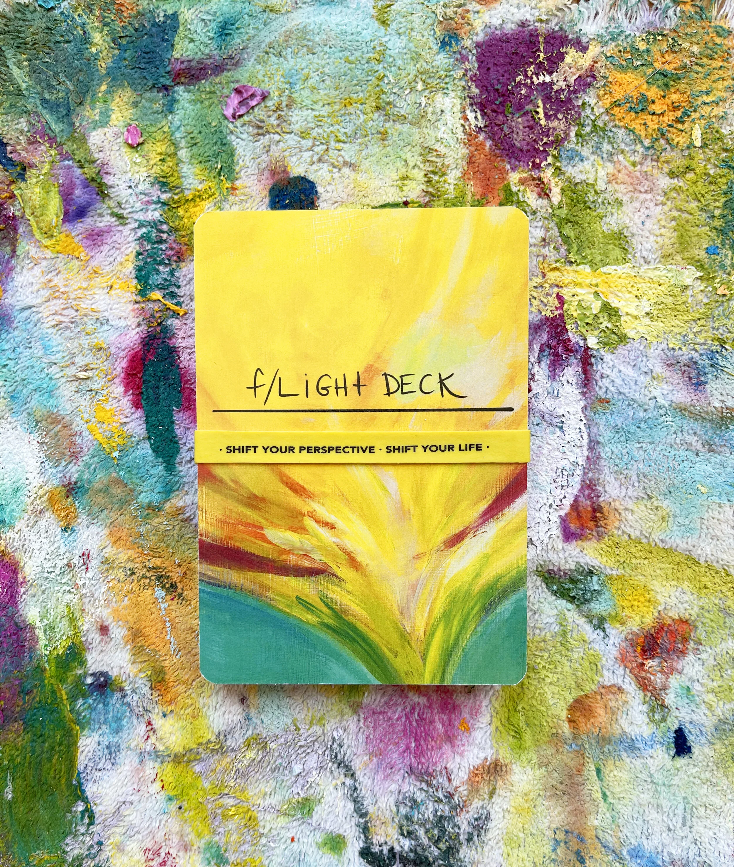 Colorful abstract painting with thick textured brushstrokes and bright colors including yellow, green, purple, pink, blue, and orange.