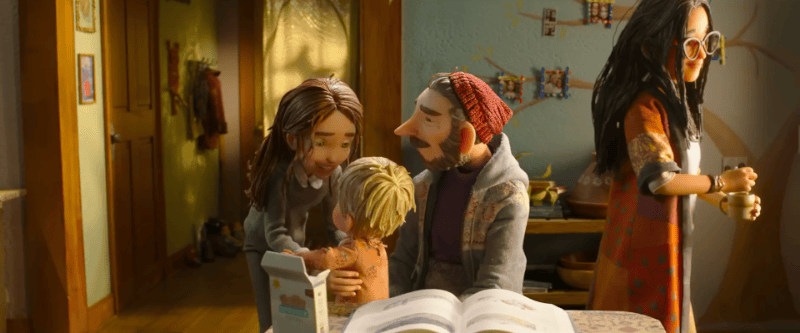 Animated scene from LAIKA's stop-motion feature Wildwood, showing Mr. McKeel, wearing a red beanie, with Prue and her younger sibling in a kitchen.