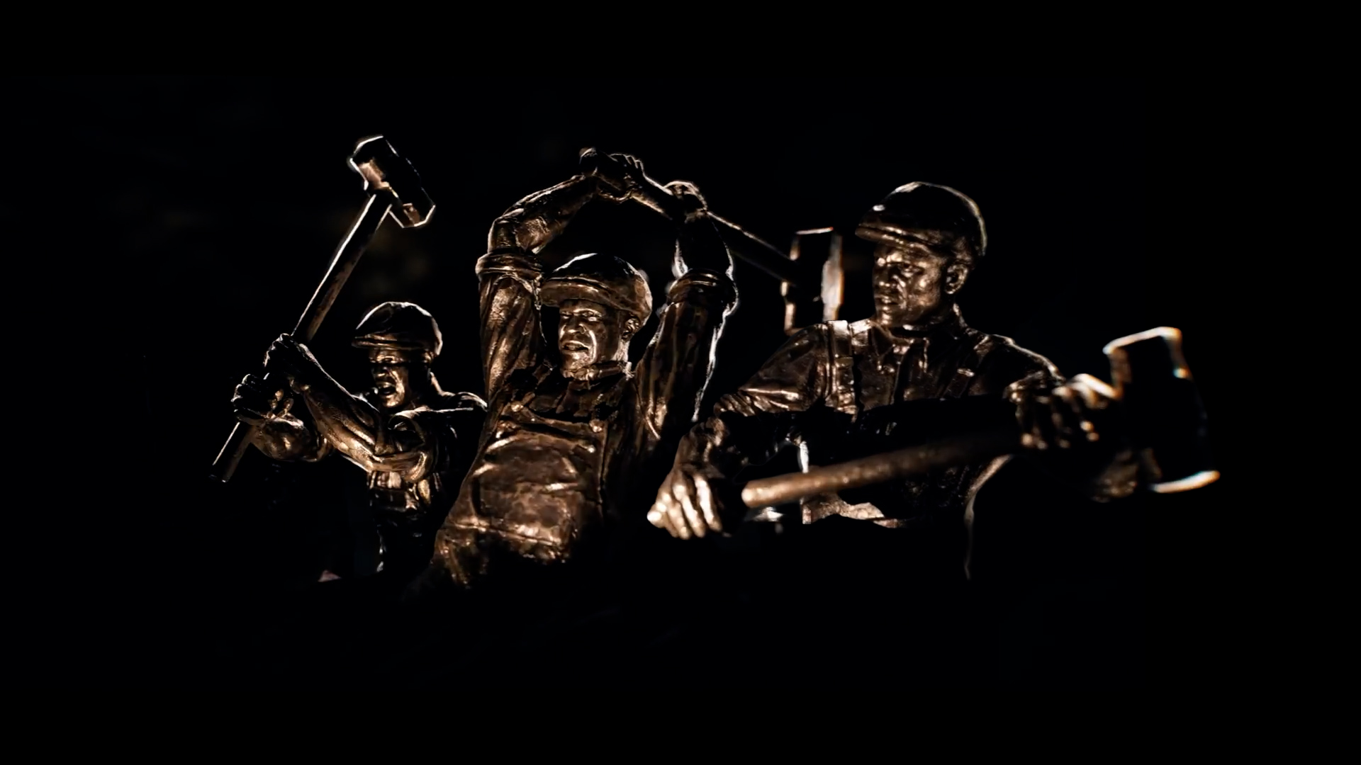 Three bronze industrial worker figures raise sledgehammers overhead, from Sid Meier's Civilization VII's official announcement teaser.