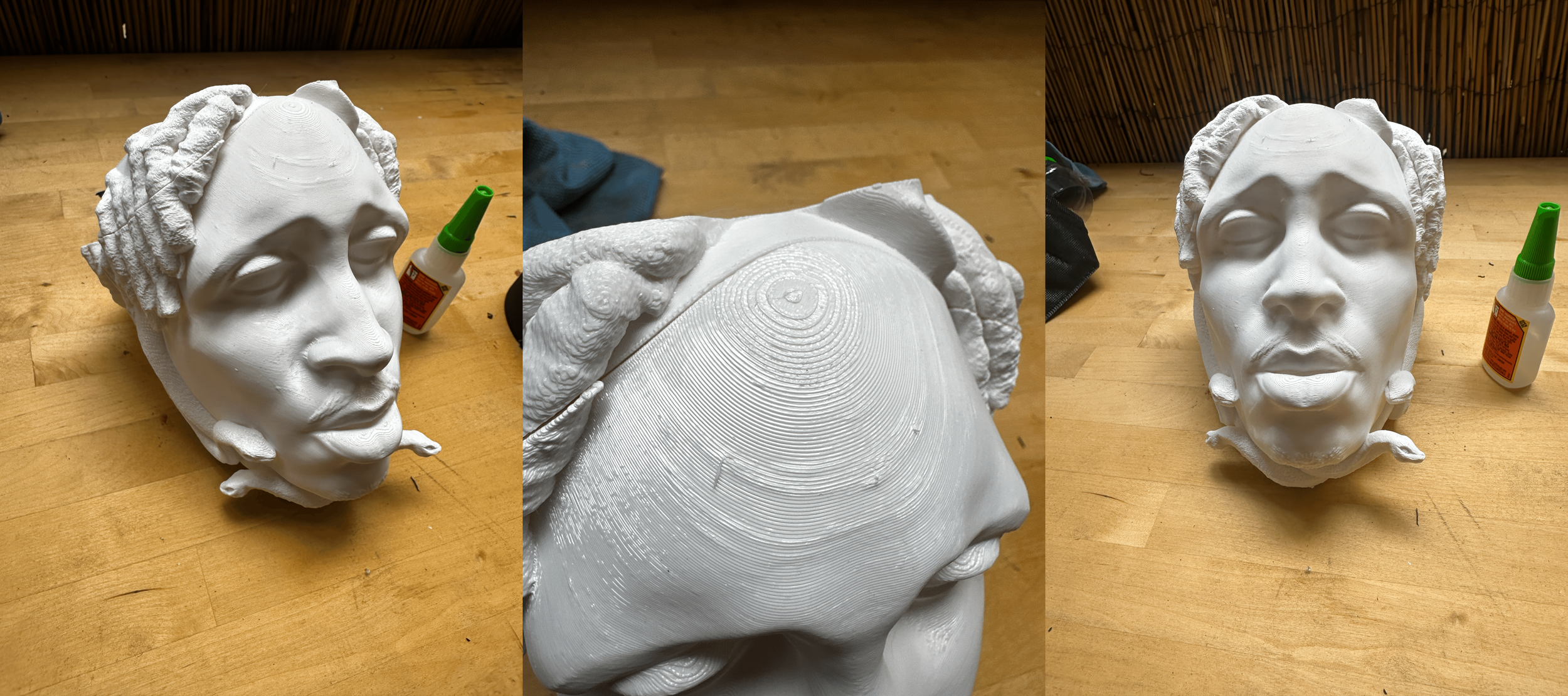 White plaster bust of a woman's face with detailed hair and earrings, placed on a wooden surface, with a small bottle of glue nearby.