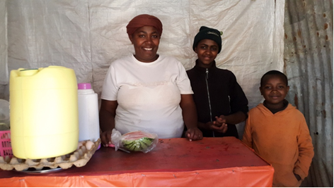 Anne with two of her children attending her business