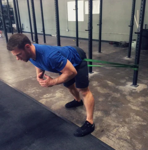 Band setup and positioning. From here, stand up then drop into your squat.