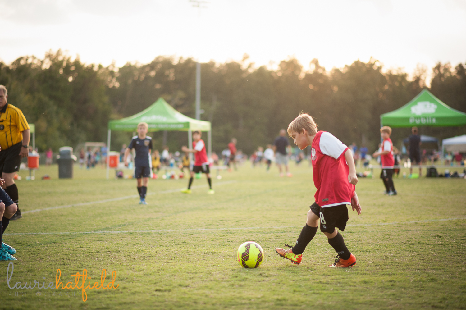 photo of boy playing soccer