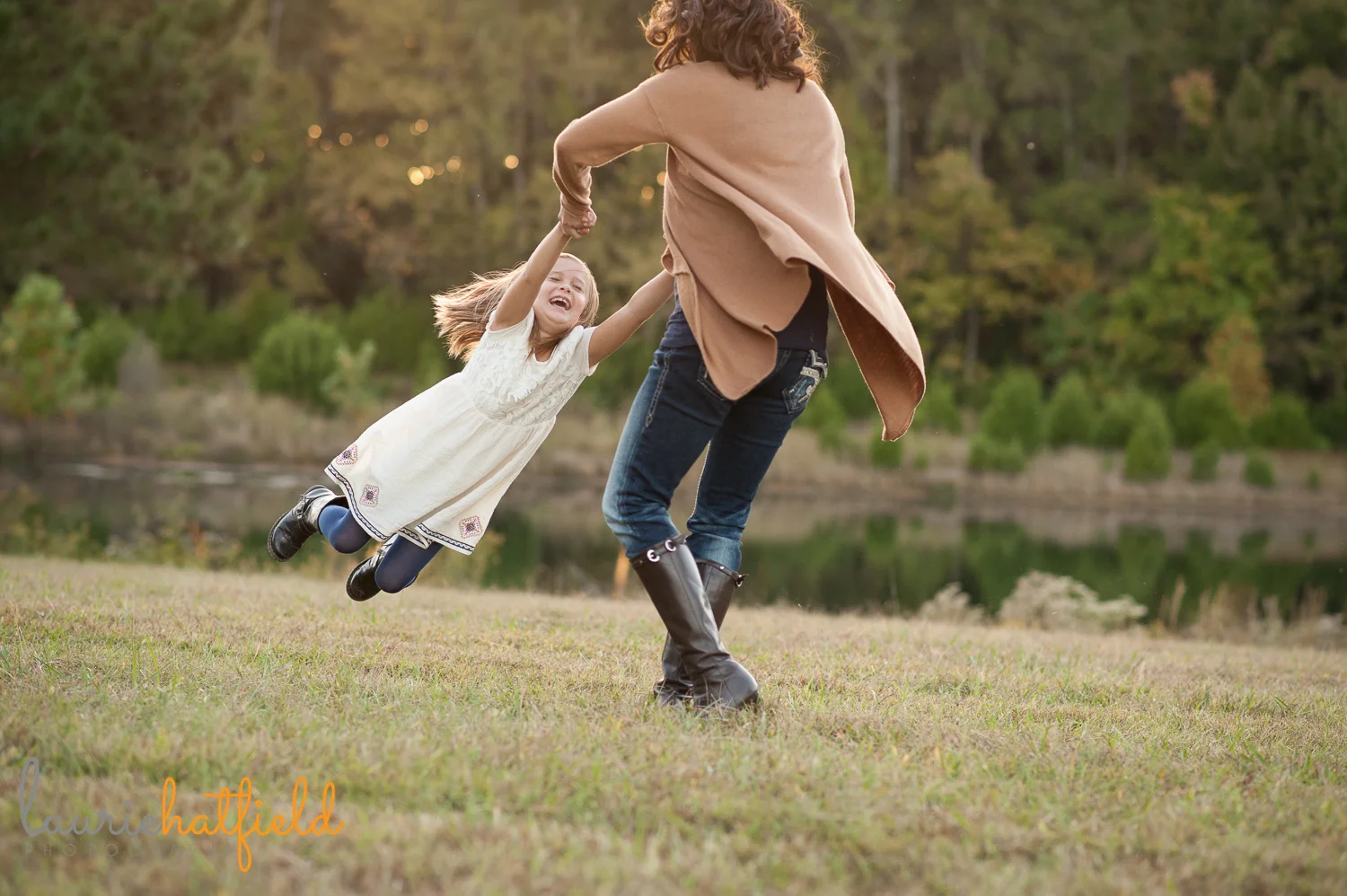 Mom swinging daughter picture