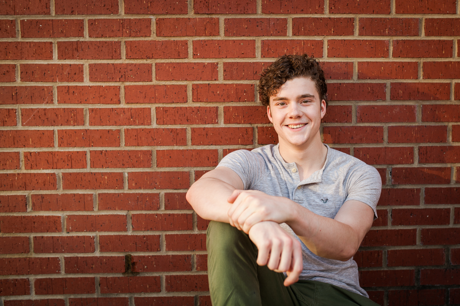 graduating guy against brick wall {huntsville senior portraits}