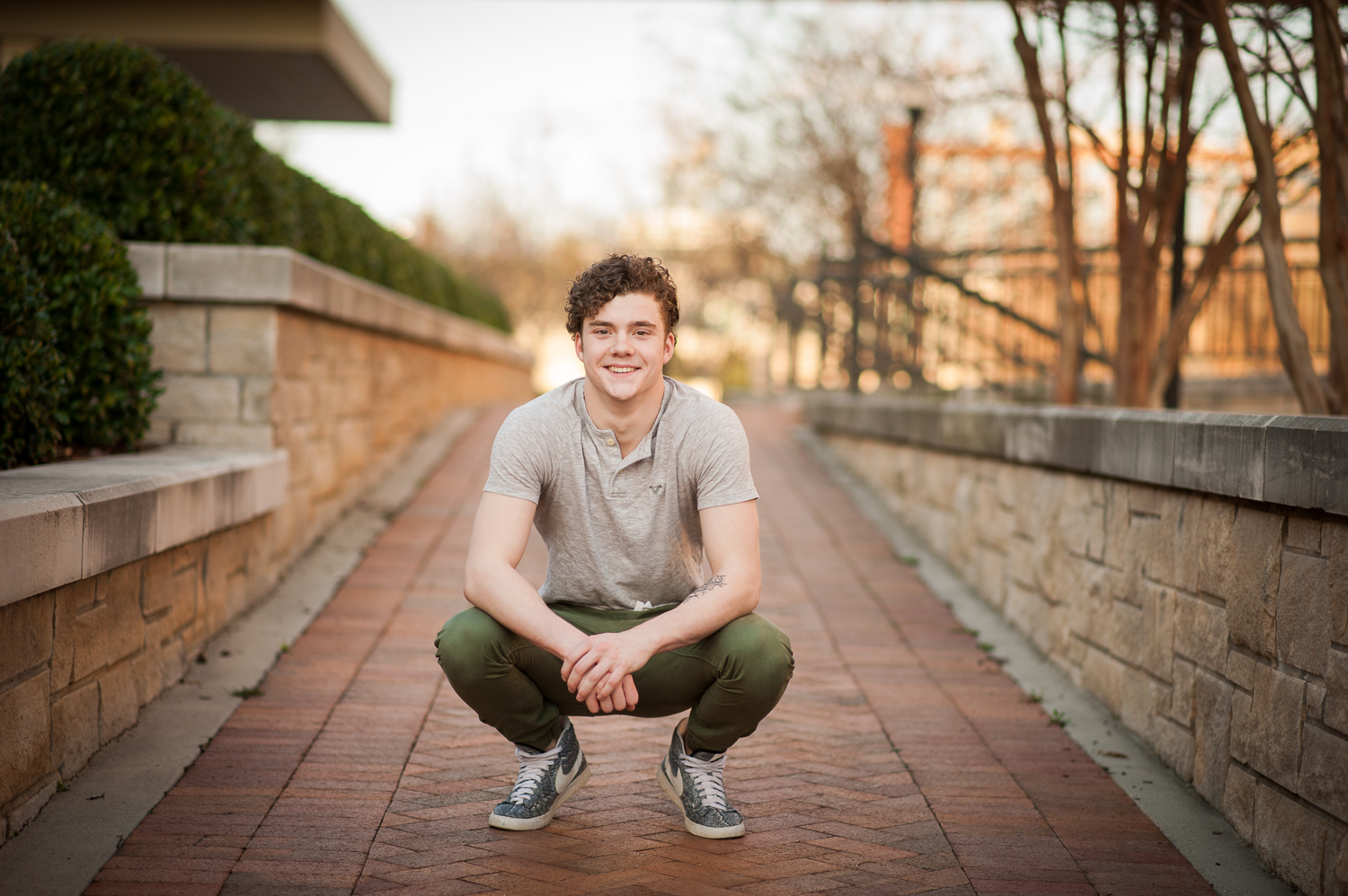 graduating guy squatting {huntsville al senior portraits}