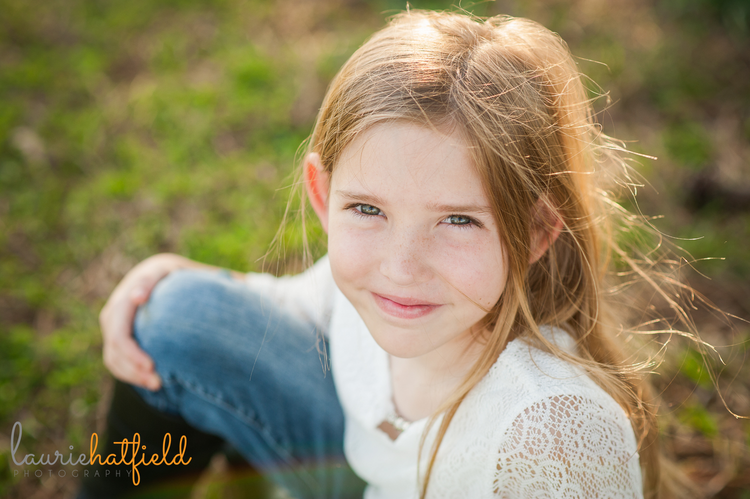 9-year-old girl sitting in grass {madison al photographer}