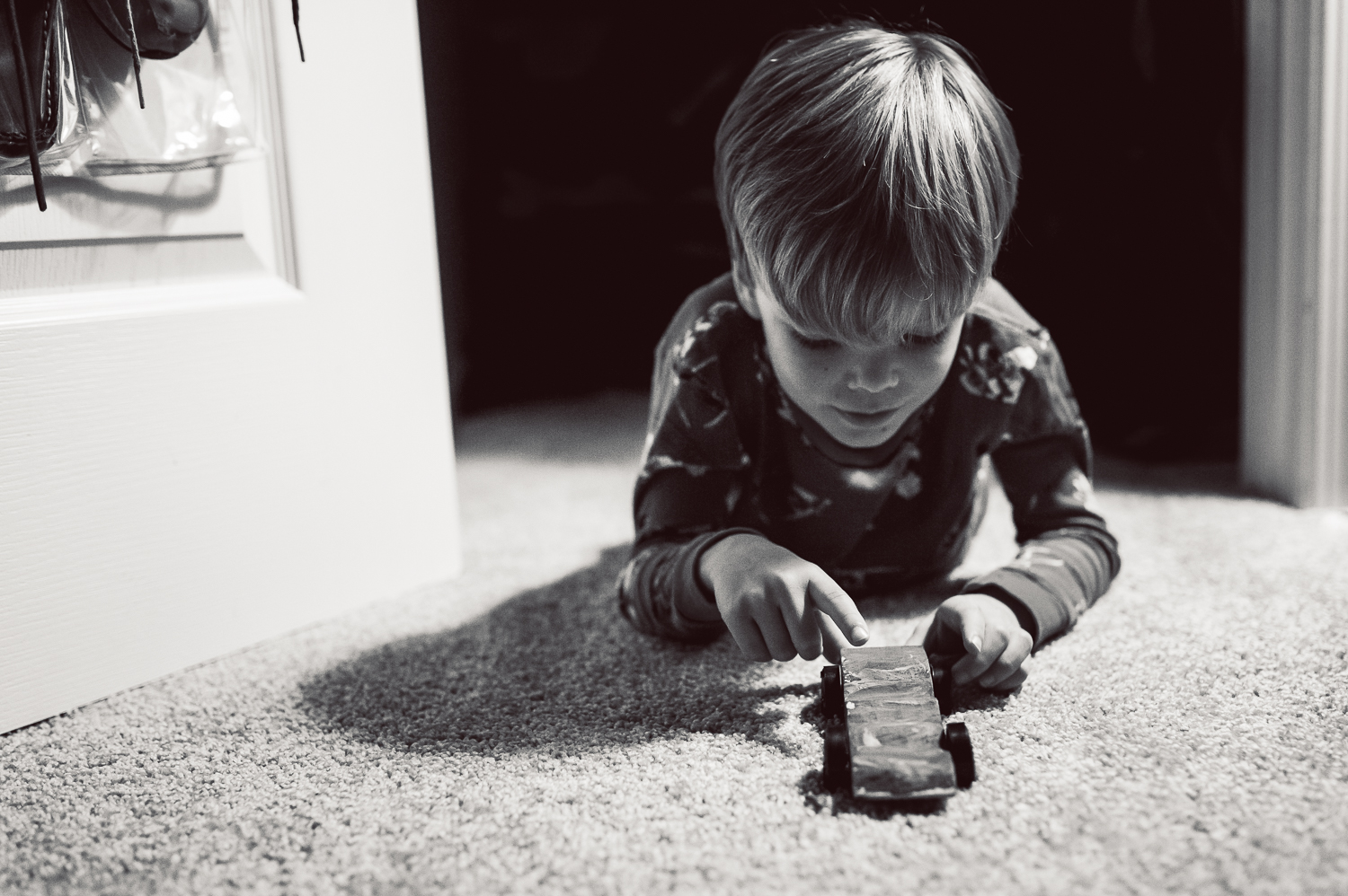 little boy playing with car on carpet | Huntsville photographer
