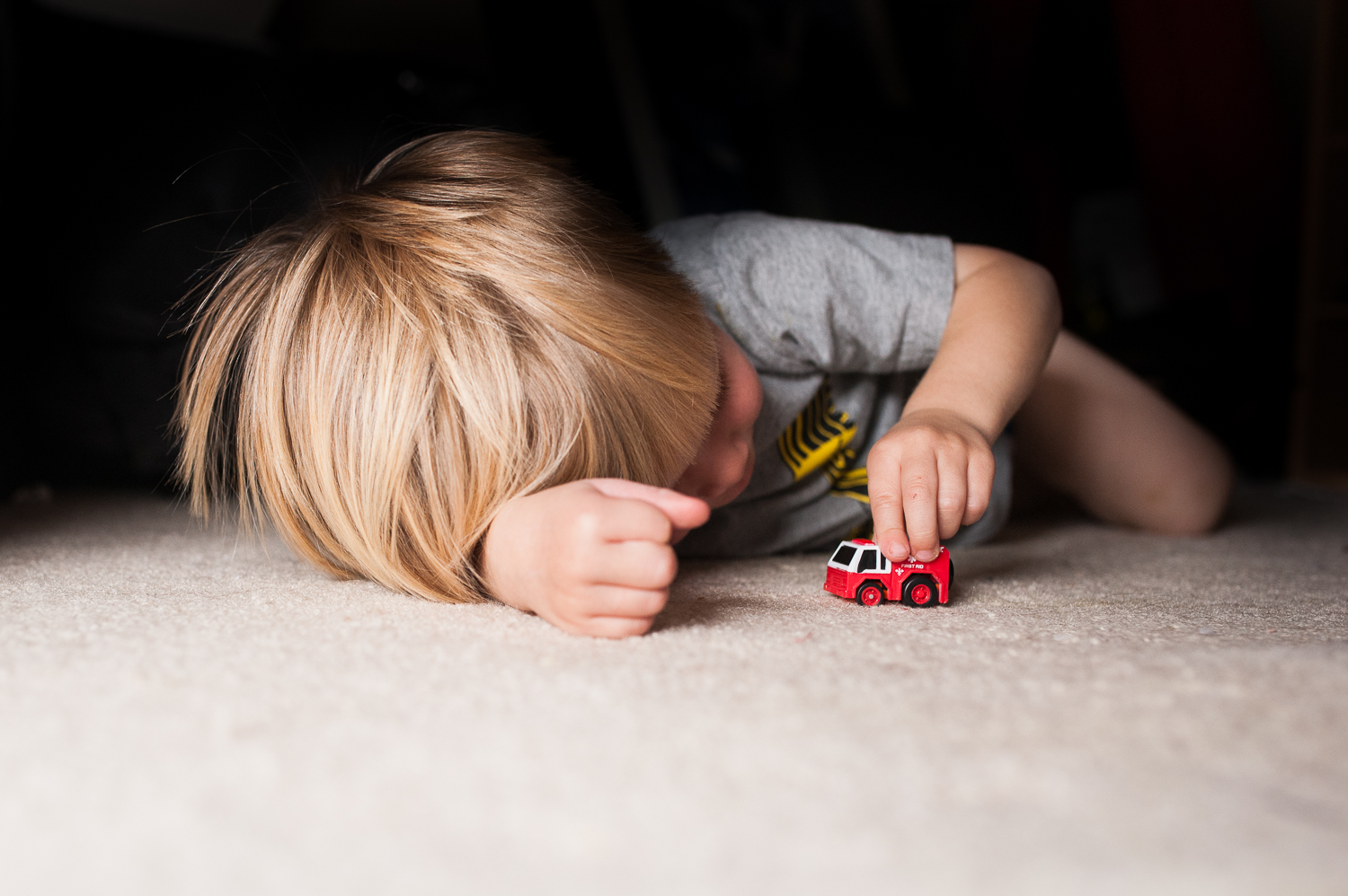 little boy playing with fire truck on carpet | Huntsville photographer