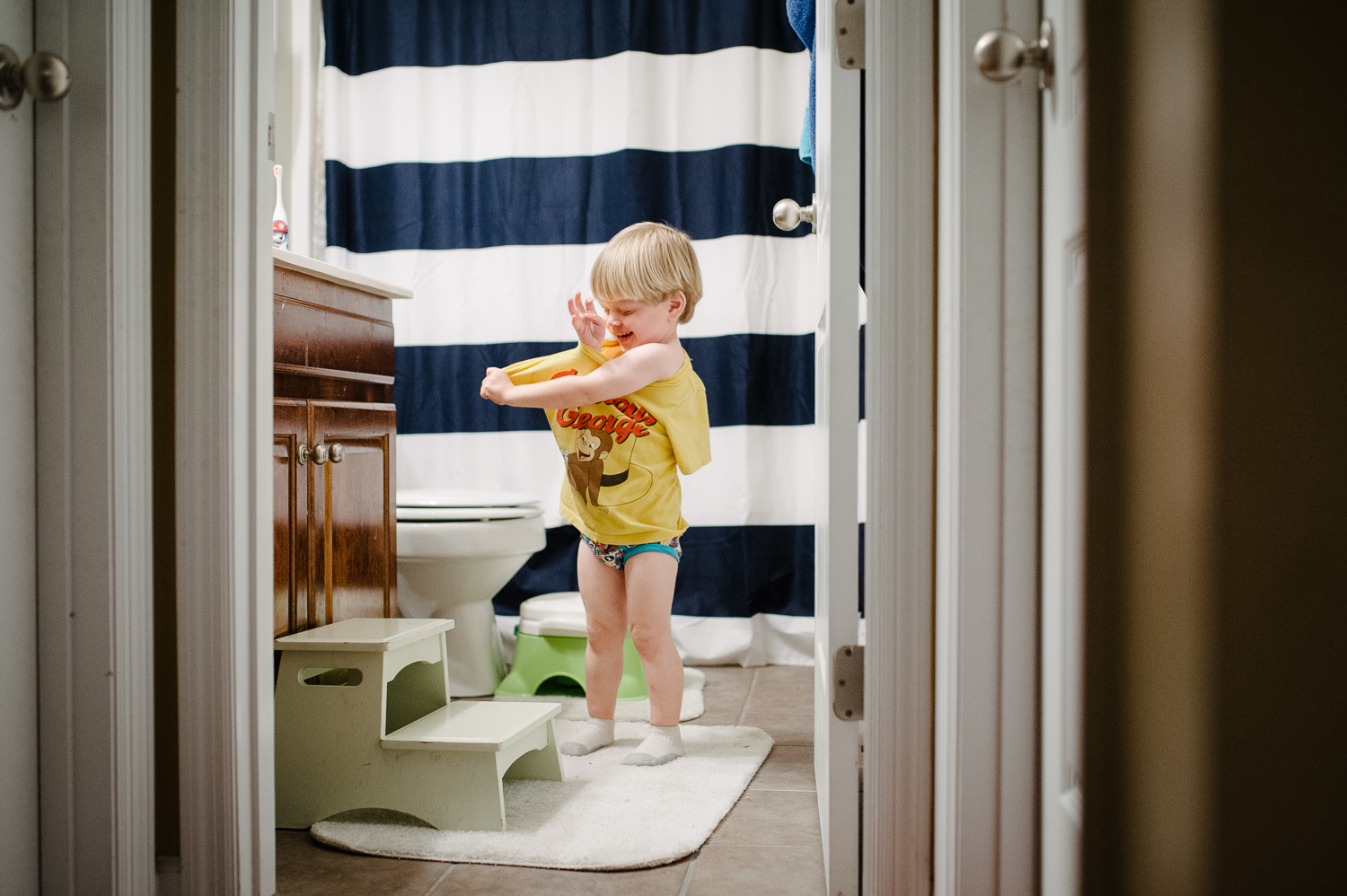 little boy in bathroom taking off shirt | Huntsville photographer