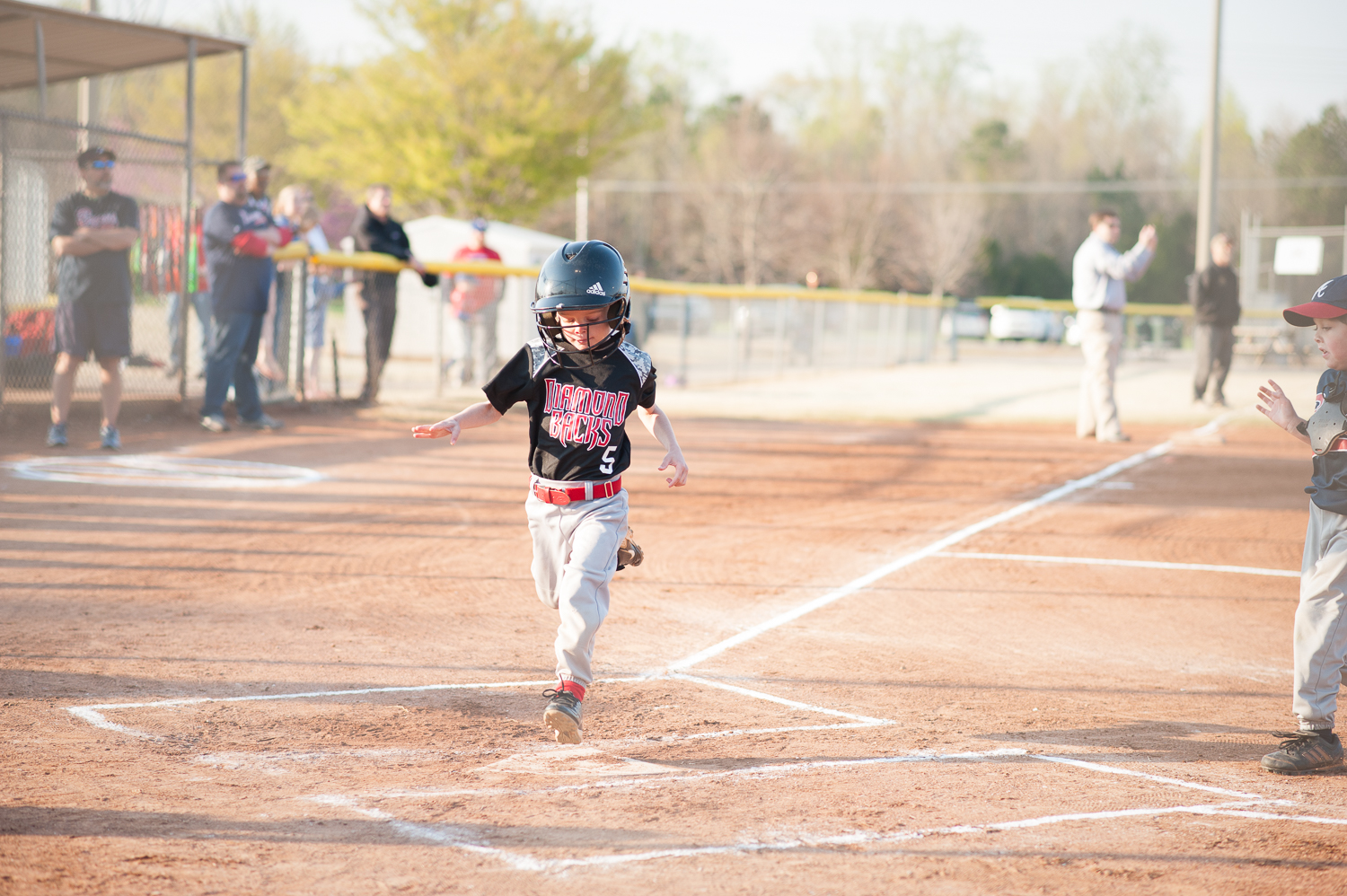 little boy scoring a run in baseball | Huntsville photographer