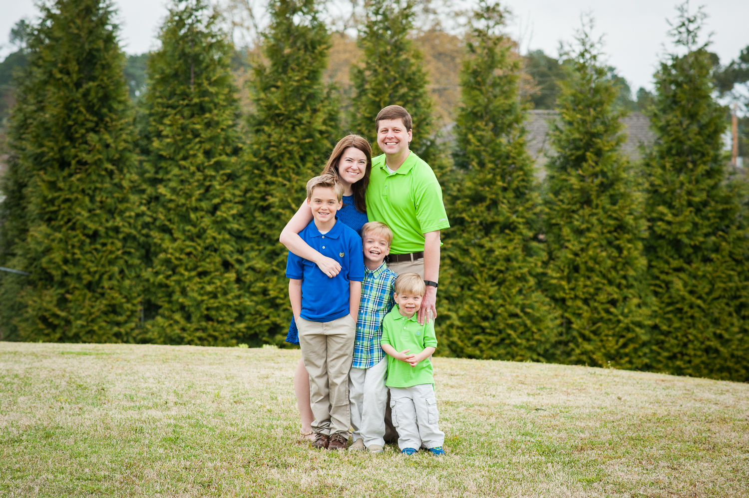 mom, dad, and 3 sons standing in grass | Huntsville photographer