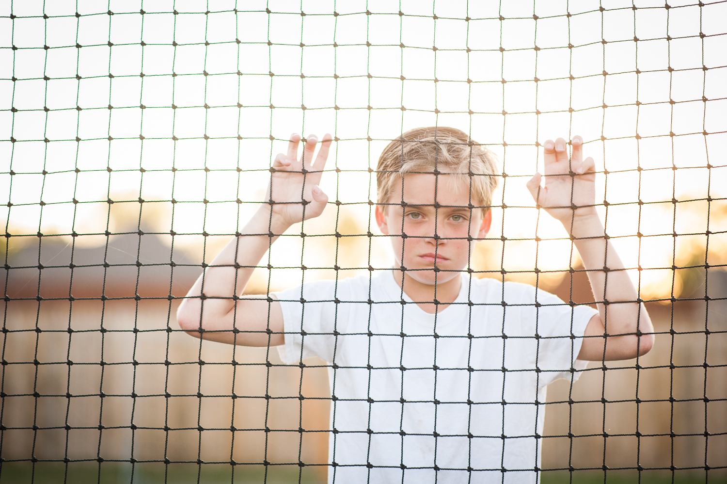 boy looking through soccer goal | Huntsville photographer