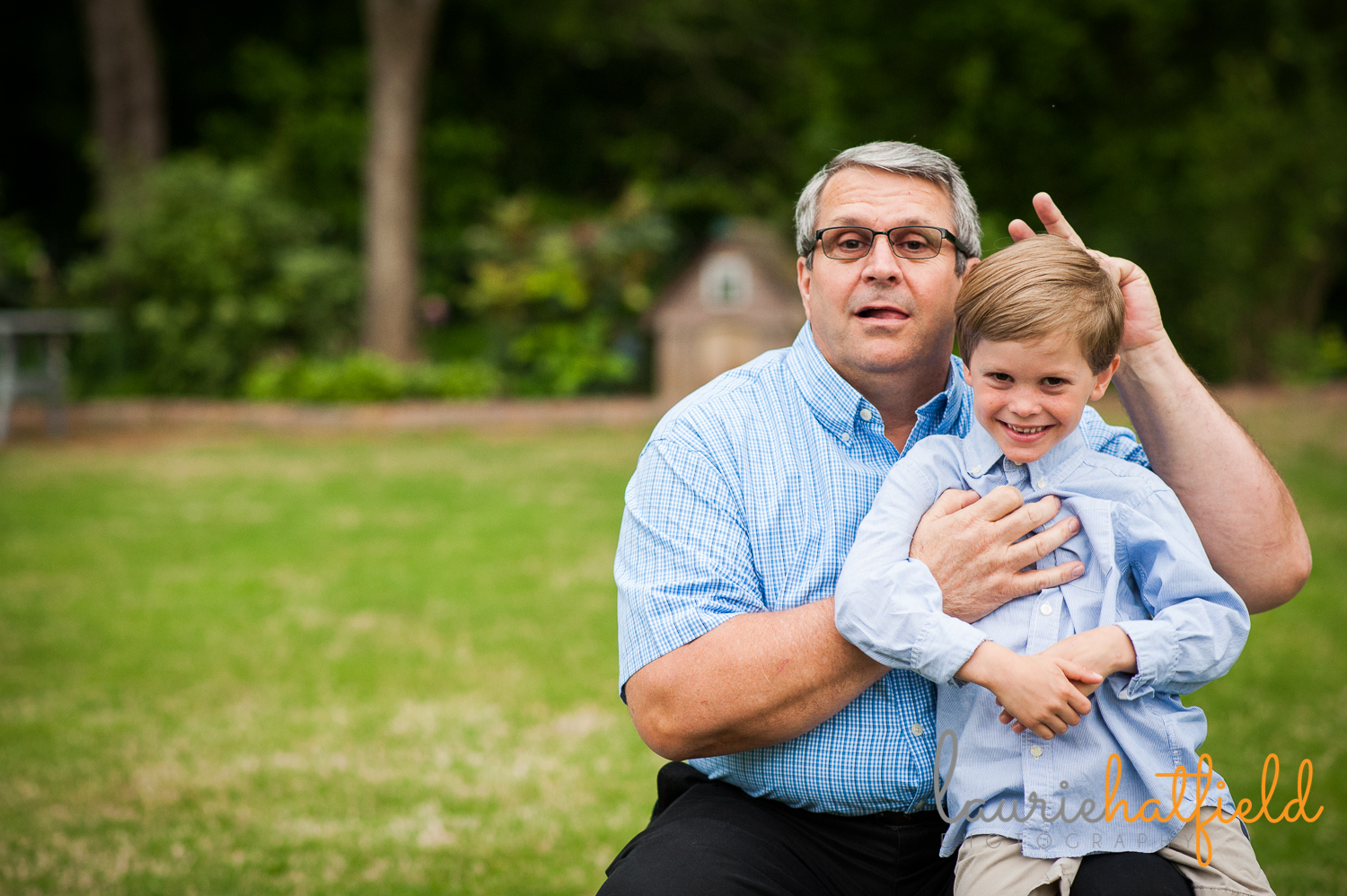 grandfather giving bunny ears to grandson | Huntsville photographer