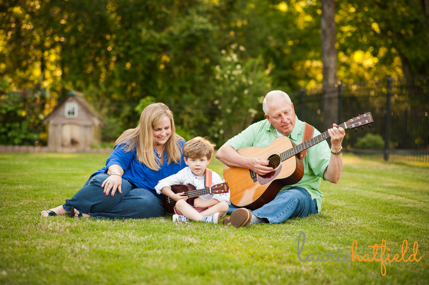 grandparents and grandson playing guitar in grass | Huntsville family photographer