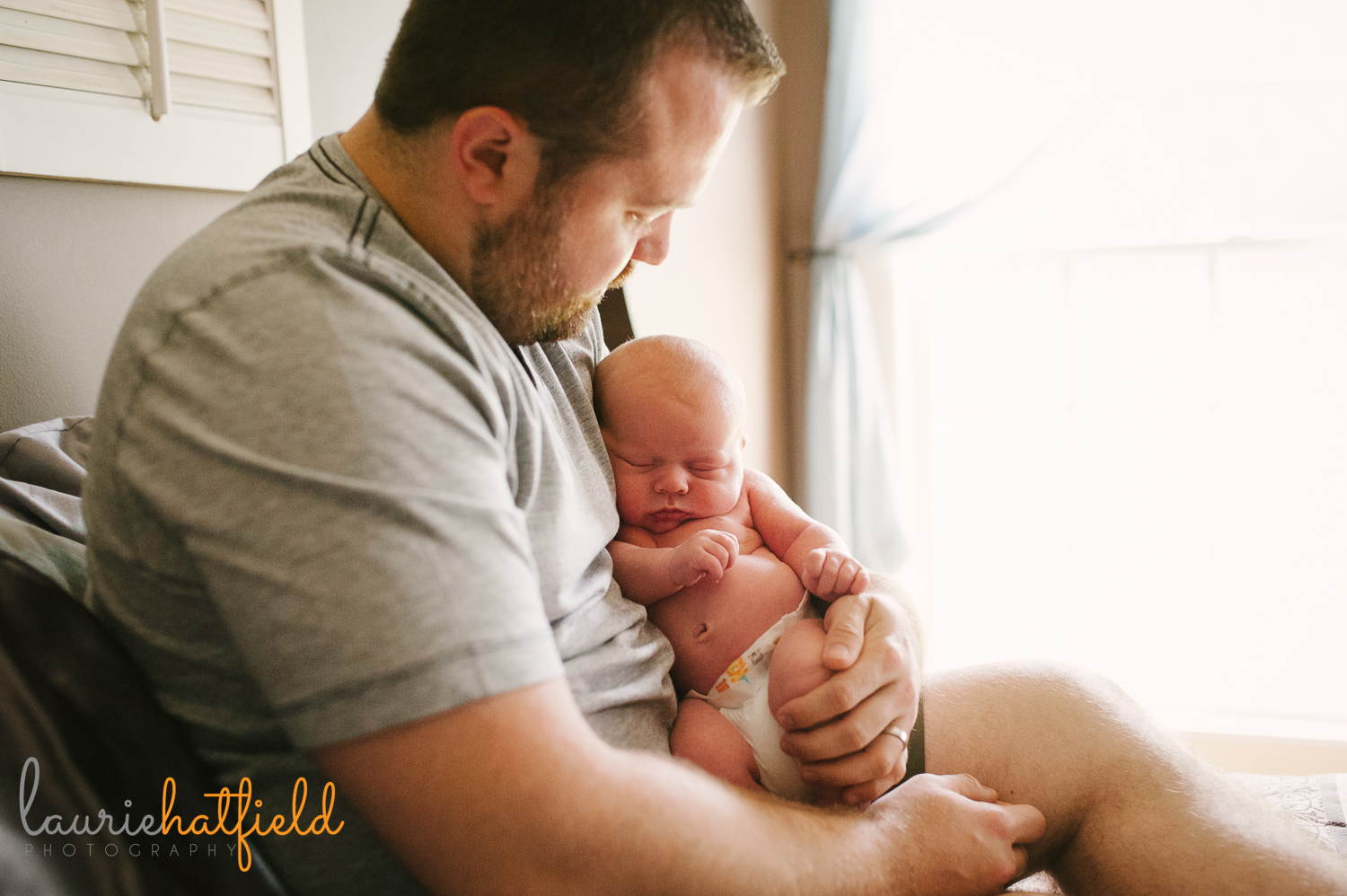 dad holding new baby boy | Huntsville newborn photographer